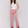 Woodrose pink front tulip hem twill pants featuring a mid-rise and bootcut leg. Unique front tulip hem detail for a stylish look by Charlie B.