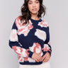 Navy fuzzy jacquard knit sweater with a floral pink pattern, featuring a crew neck and drop-shoulder design by Charlie B.