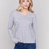 Light grey v-neck sweater with heart stitch design, featuring long sleeves and a relaxed fit by Charlie B.