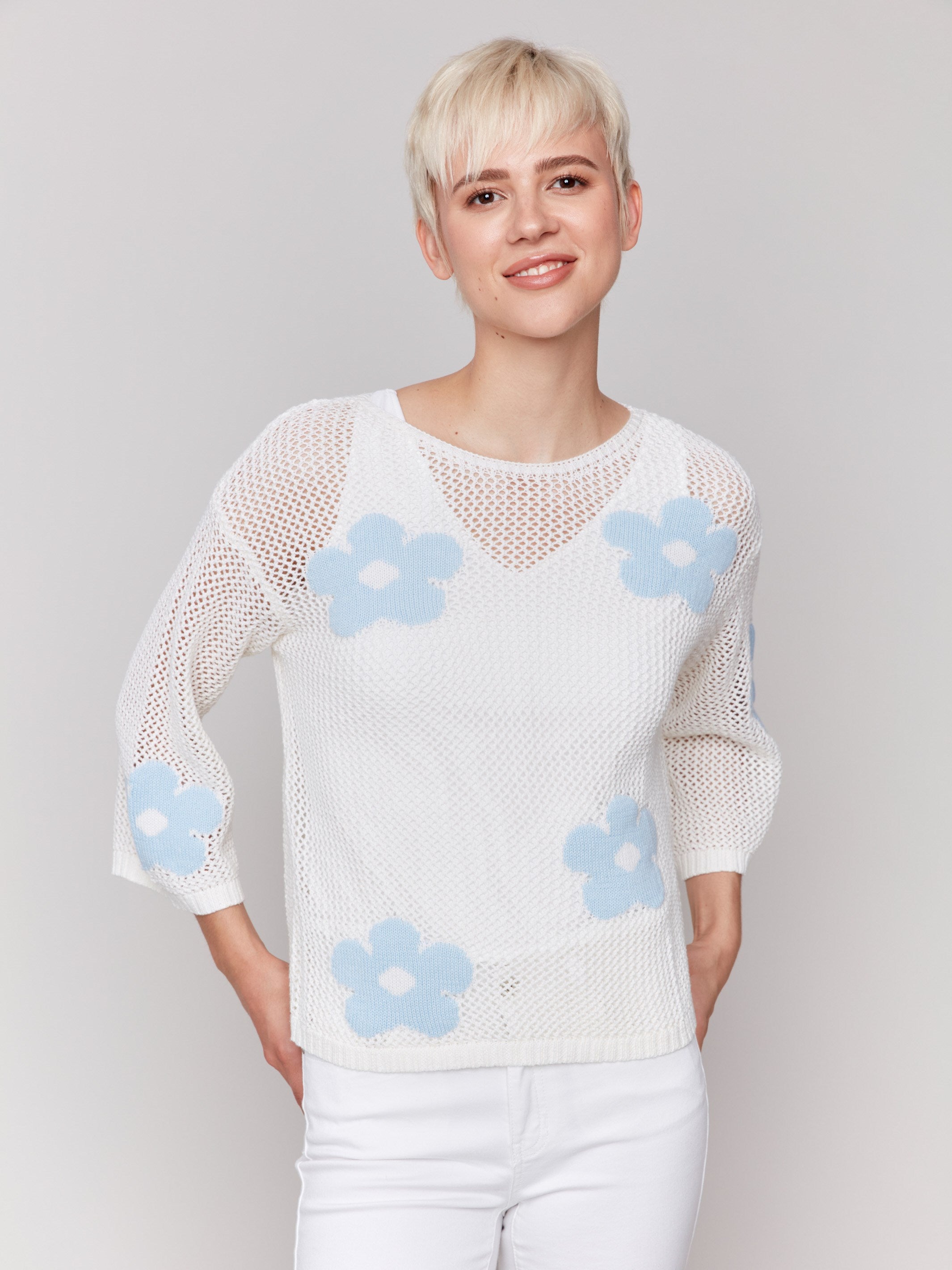 White crochet sweater featuring a round neckline by Charlie B.