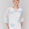 White crochet sweater featuring a round neckline by Charlie B.