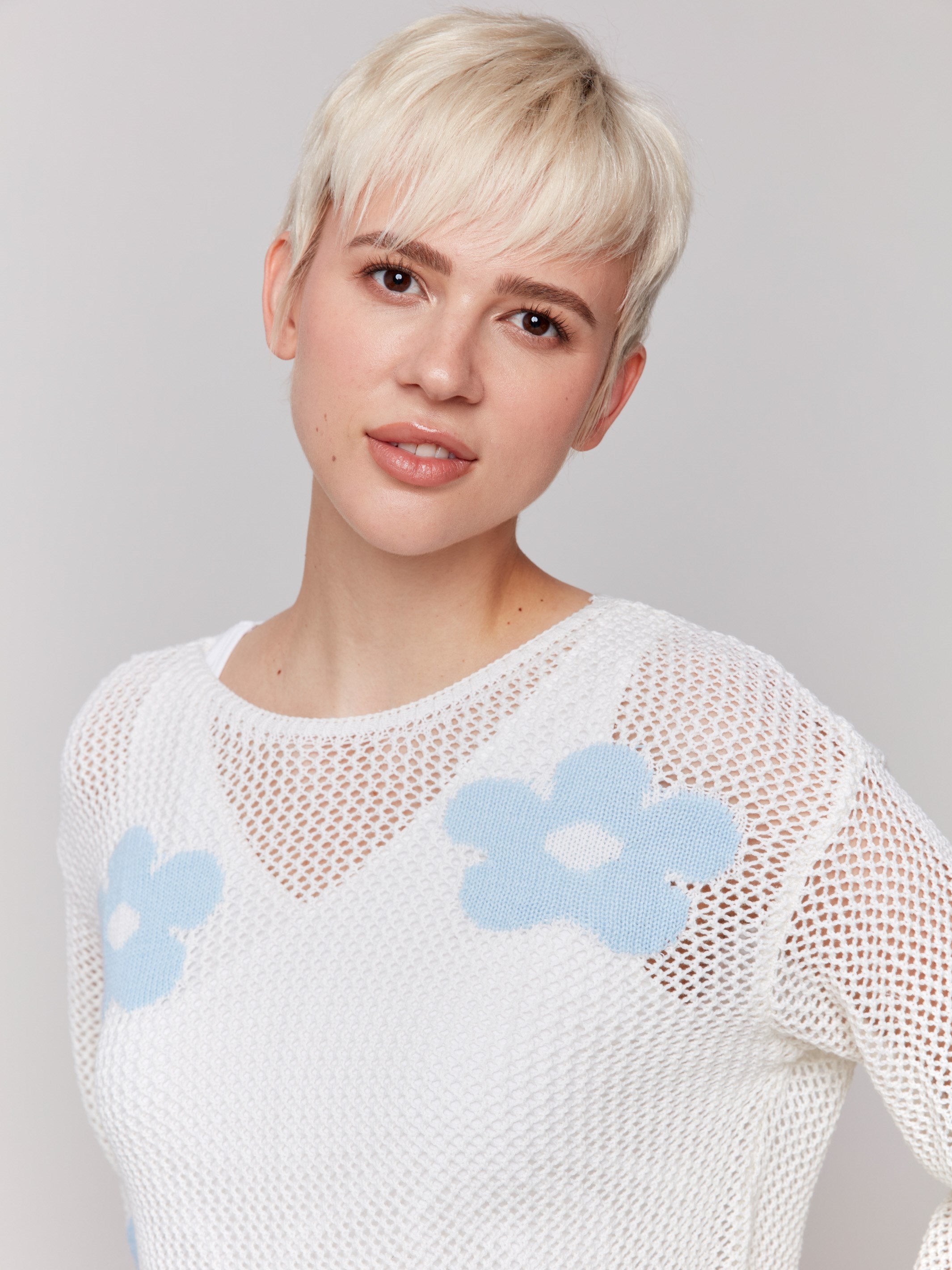 Elegant white crochet sweater with floral pattern by Charlie B.