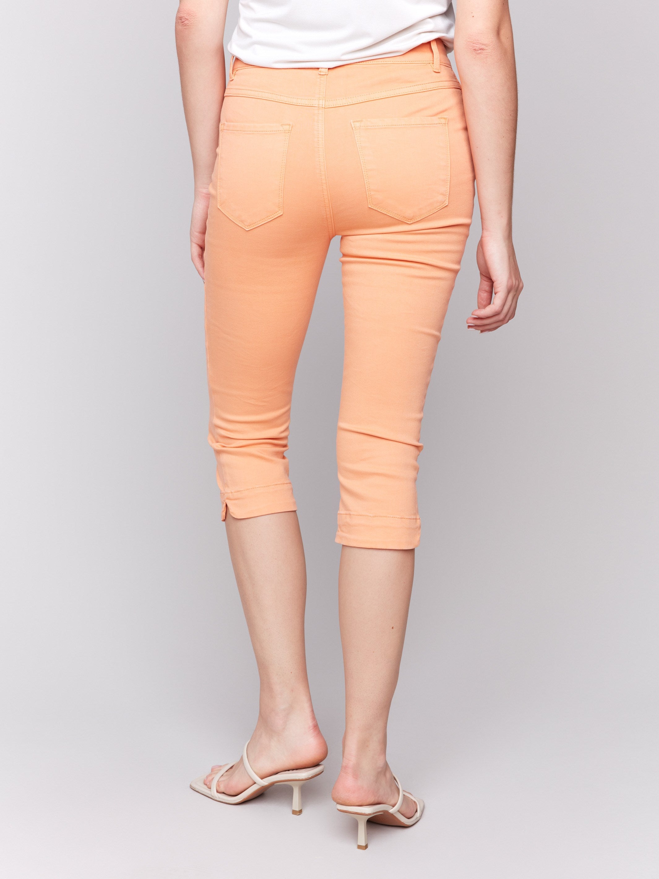 Classic five-pocket style adds functionality to these capri pants by Charlie B.