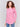 Magenta pink long-sleeved knit sweater with lace-up cuffs, rounded hem, and front pockets by Charlie B.