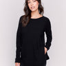 Black long-sleeved knit sweater with lace-up cuffs, rounded hem, and front pockets by Charlie B.