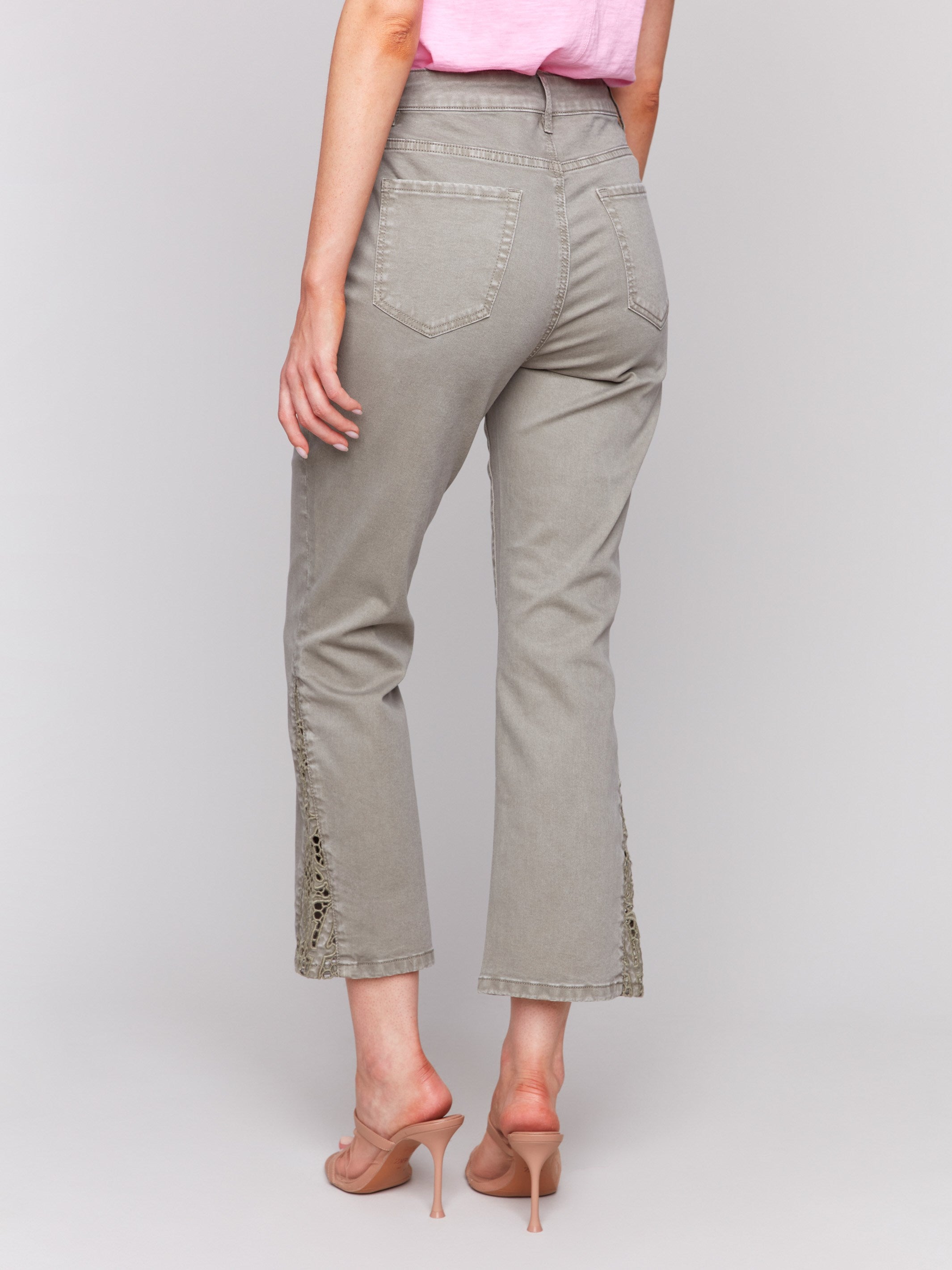 Pants in celadon with elegant lace cuts on the sides by Charlie B.