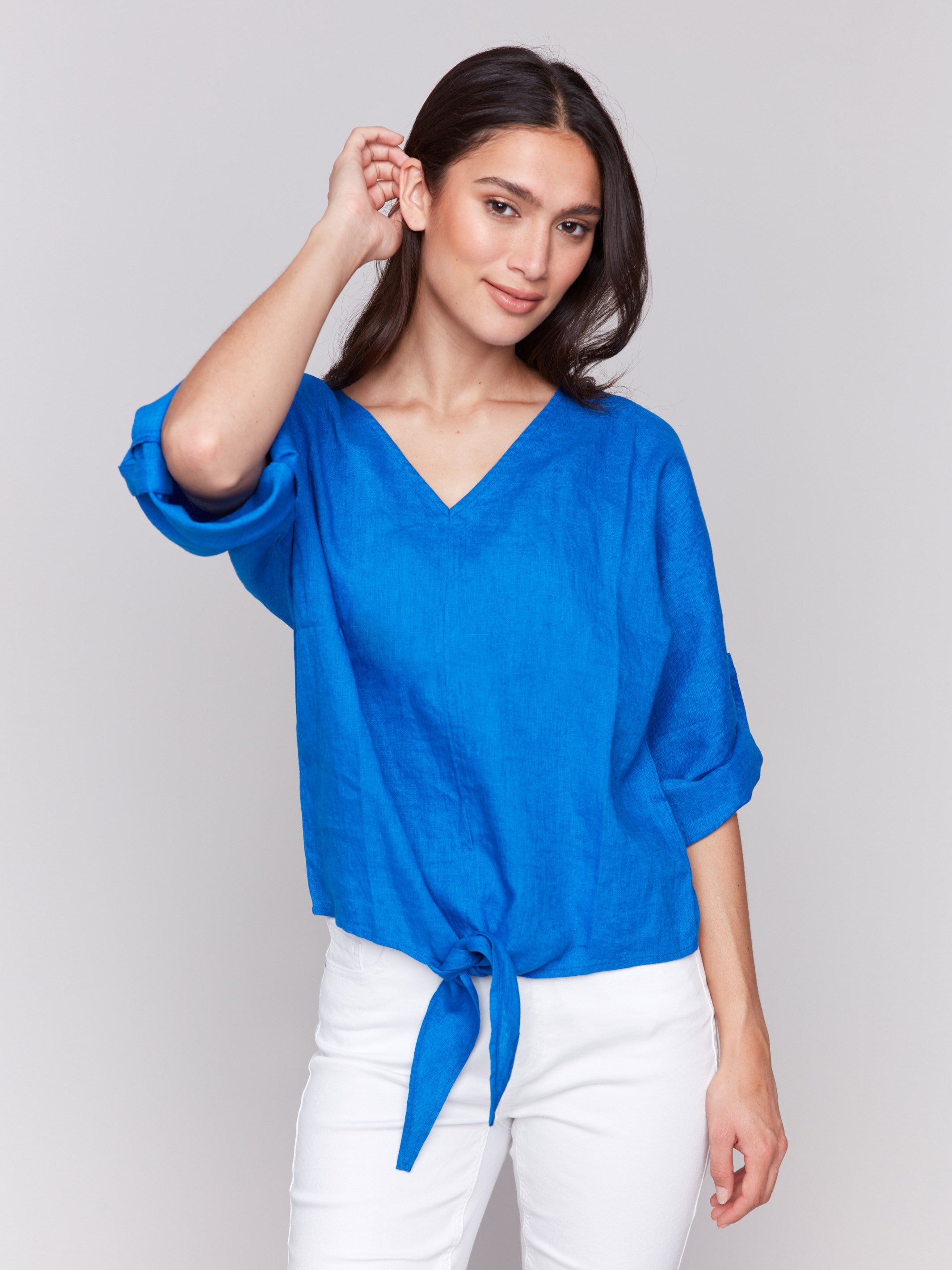 Chic top featuring a front tie knot at the hem by Charlie B.