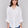 Gold linen tunic blouse with embroidered hearts, featuring a long button-down design, drop shoulders, and roll-up sleeves by Charlie B.