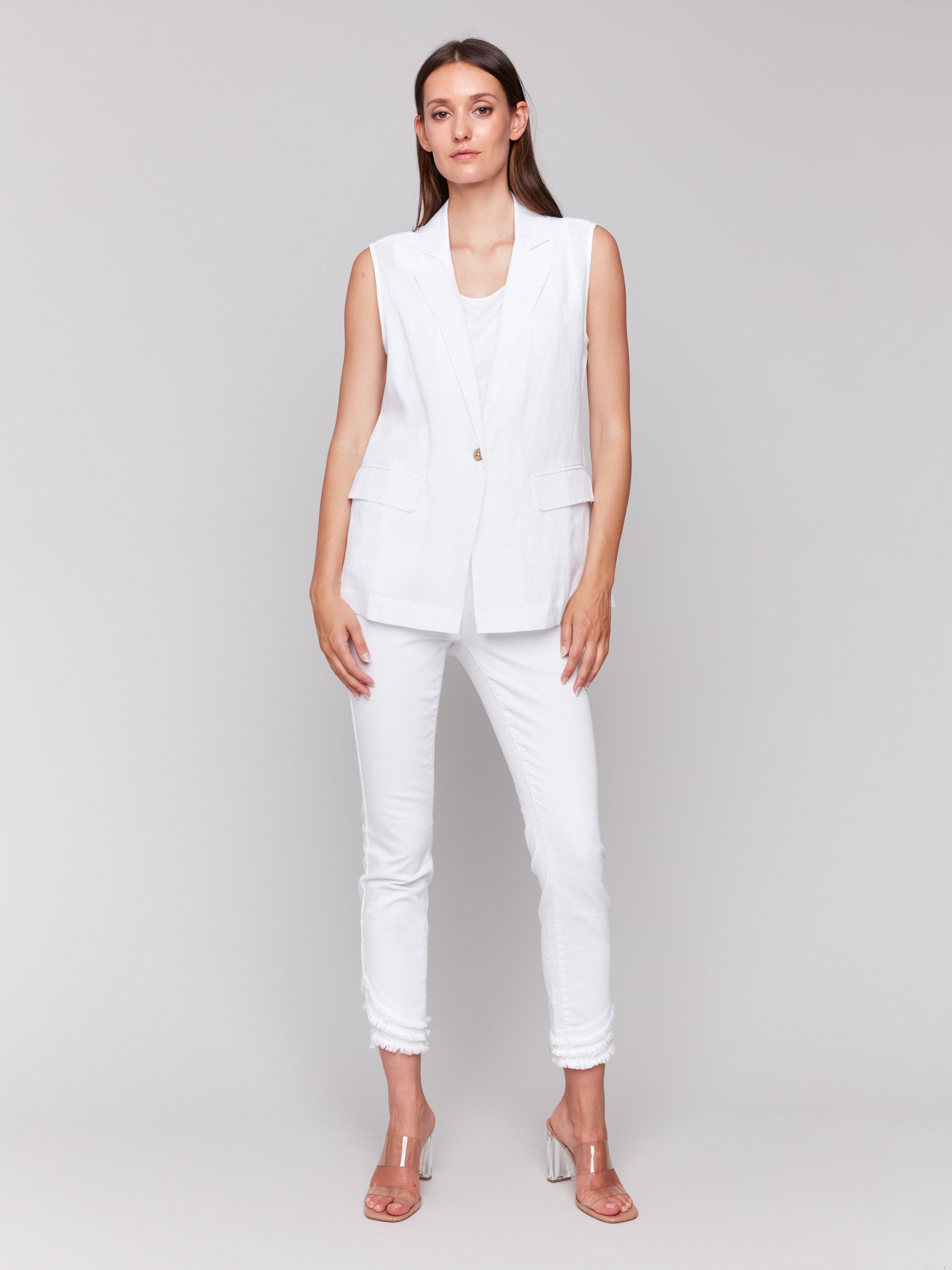 Elegant sleeveless design of a white linen blend vest by Charlie B., complementing the ensemble.