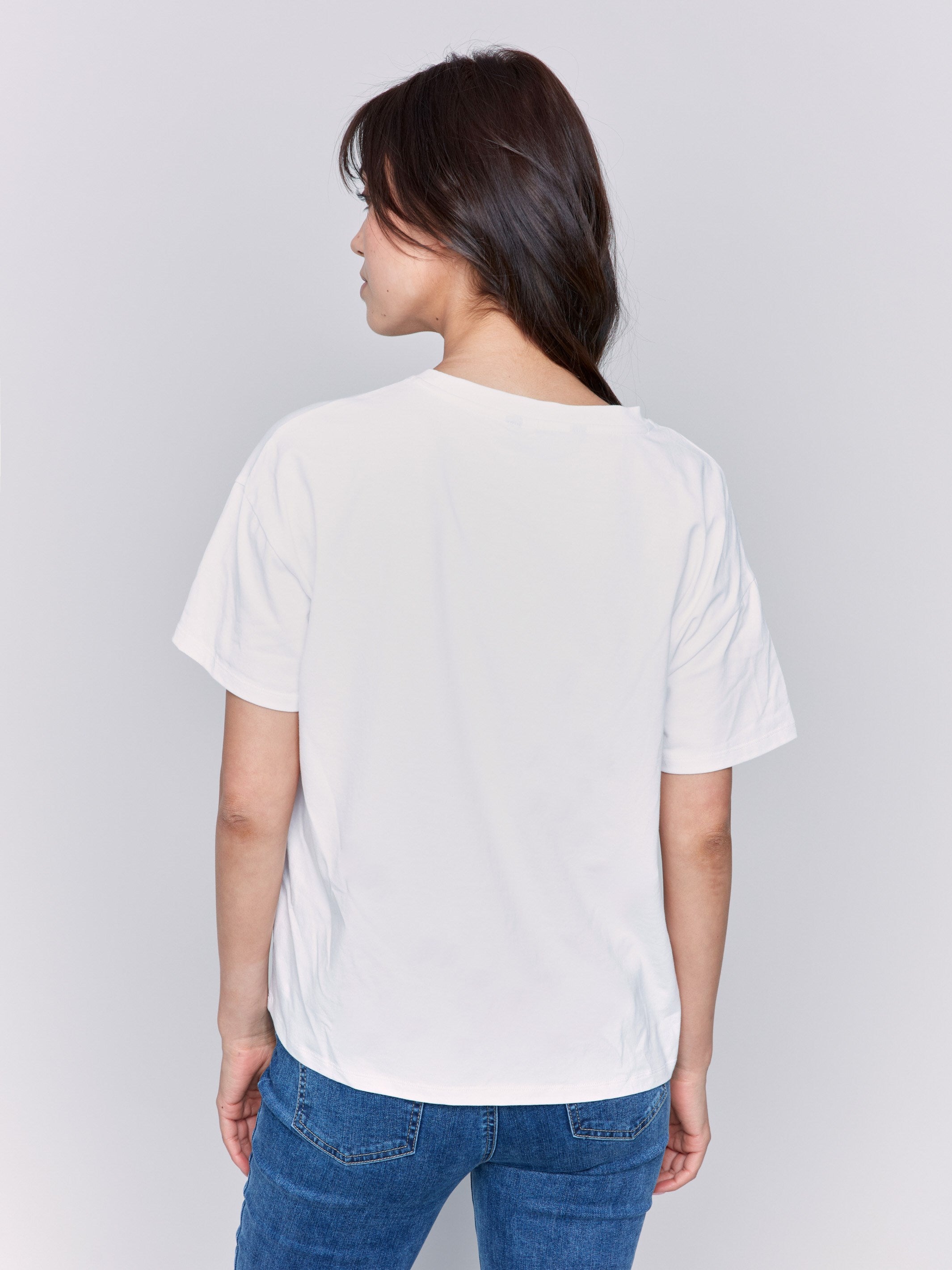 Short sleeves on loose-fit white t-shirt by Charlie B.