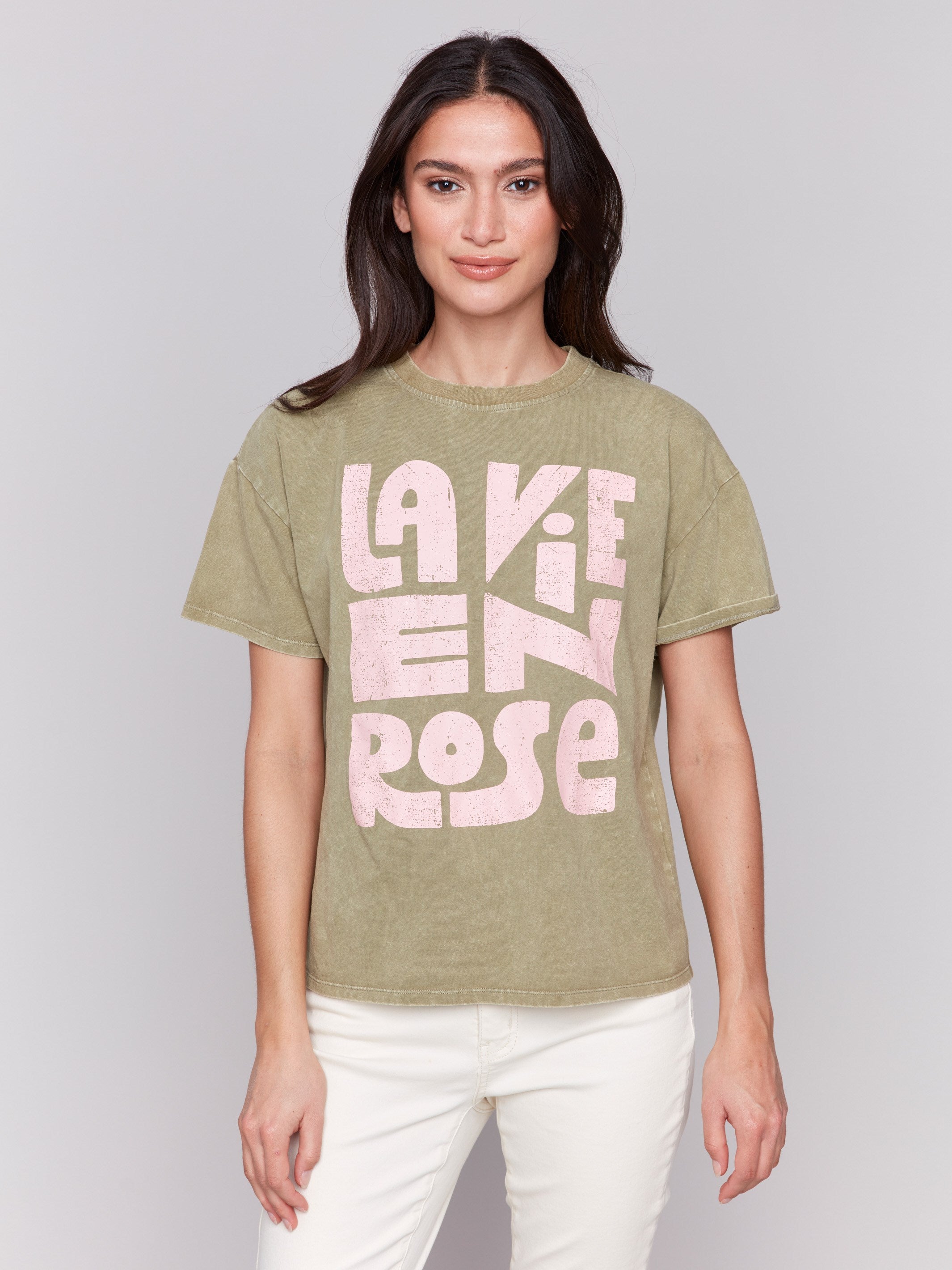 Celadon green t-shirt with crew neckline and pink graphic by Charlie B.