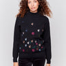 Black long-sleeve mock neck sweater with colorful floral embroidery by Charlie B.