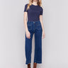 Indigo blue jeans with front patch pockets and a flared leg, featuring a mid-rise by Charlie B.