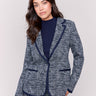 Navy plaid knit blazer with a notched lapel collar, integrated hood, and single-breasted button closure by Charlie B.