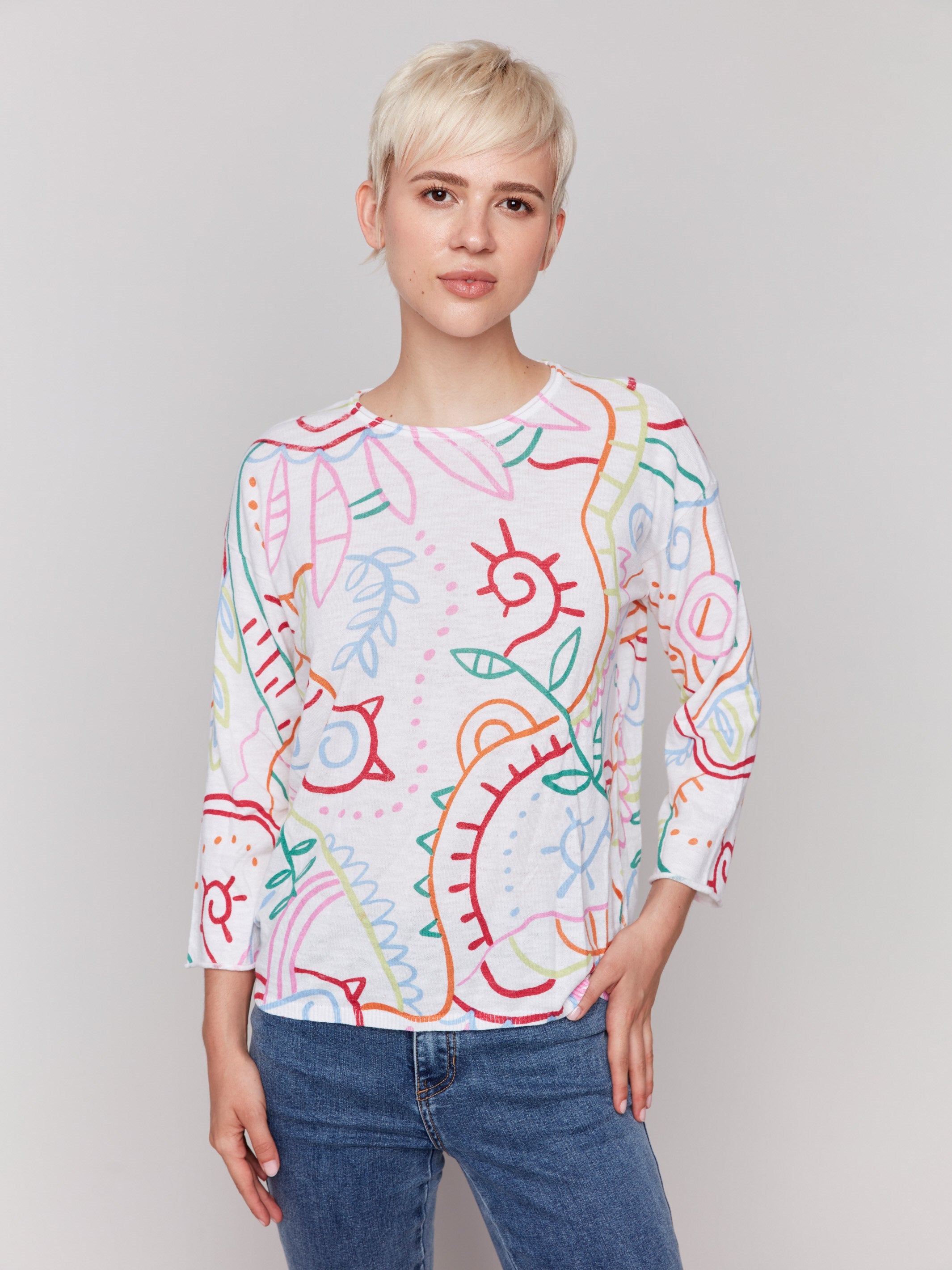 White cotton sweater with a round neckline and abstract multicolor print by Charlie B.