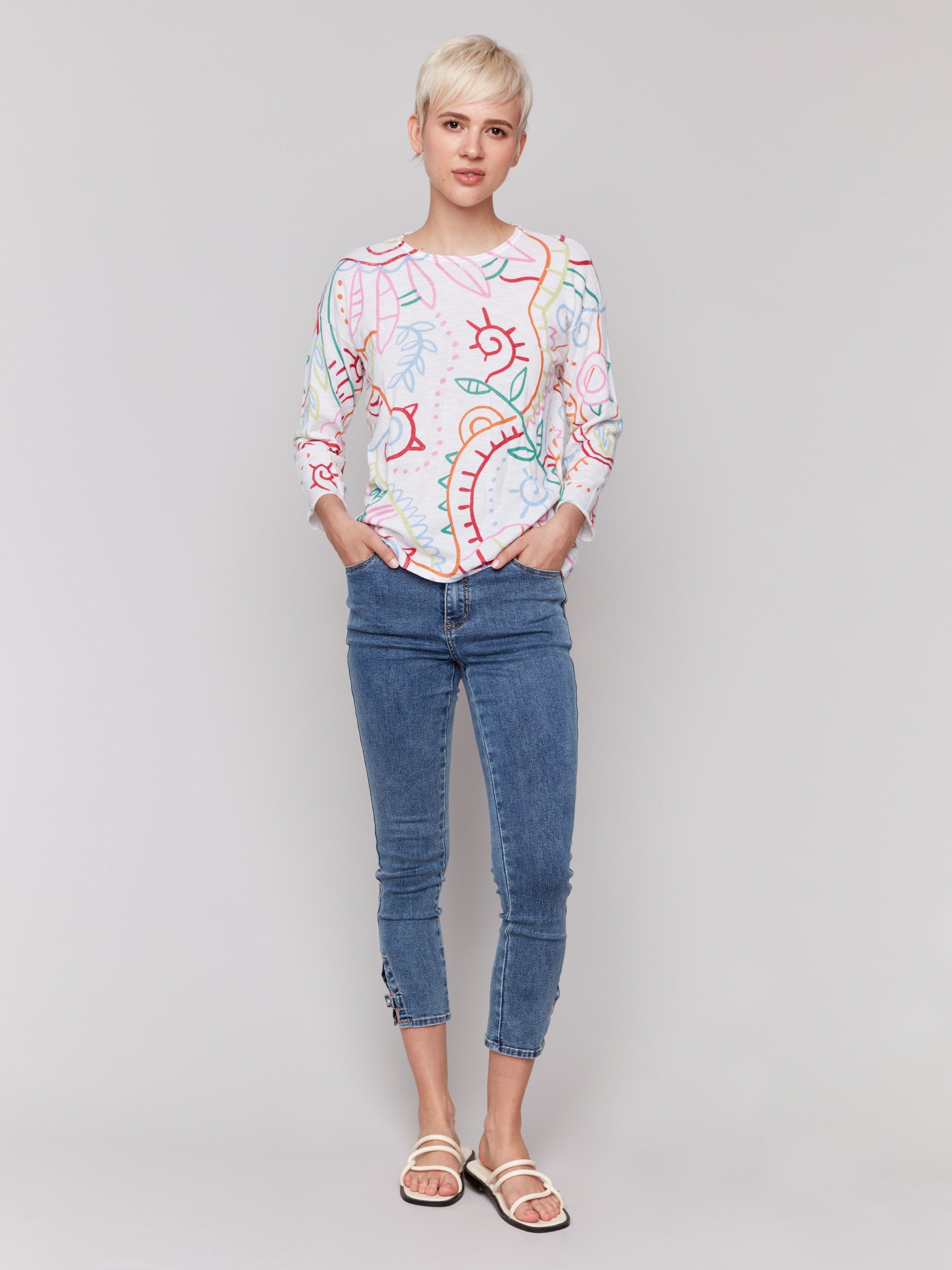 Abstract pattern adds a vibrant touch to this white cotton sweater by Charlie B.