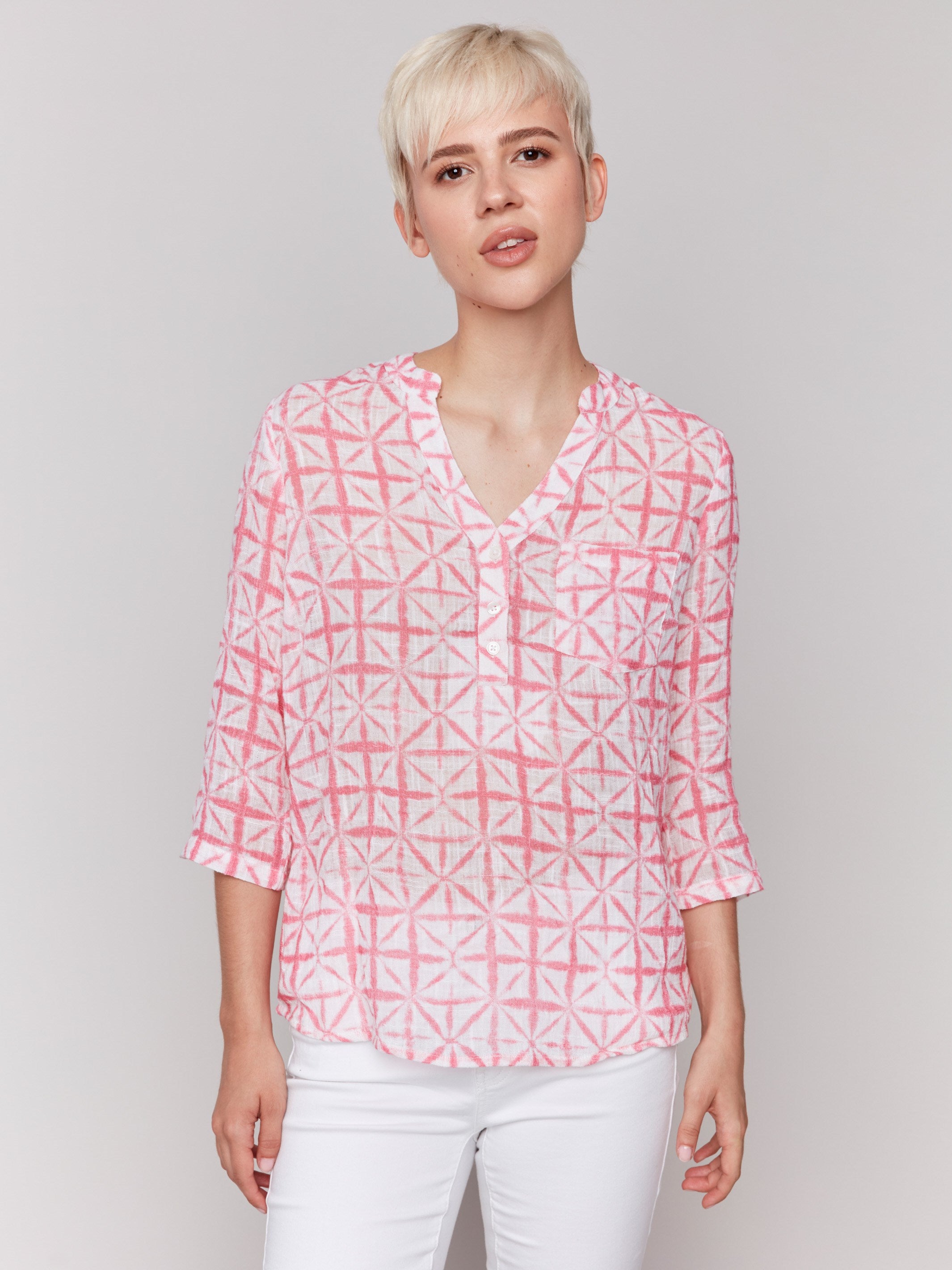 Geometric pattern blouse with a half-button front and vibrant colors by Charlie B.