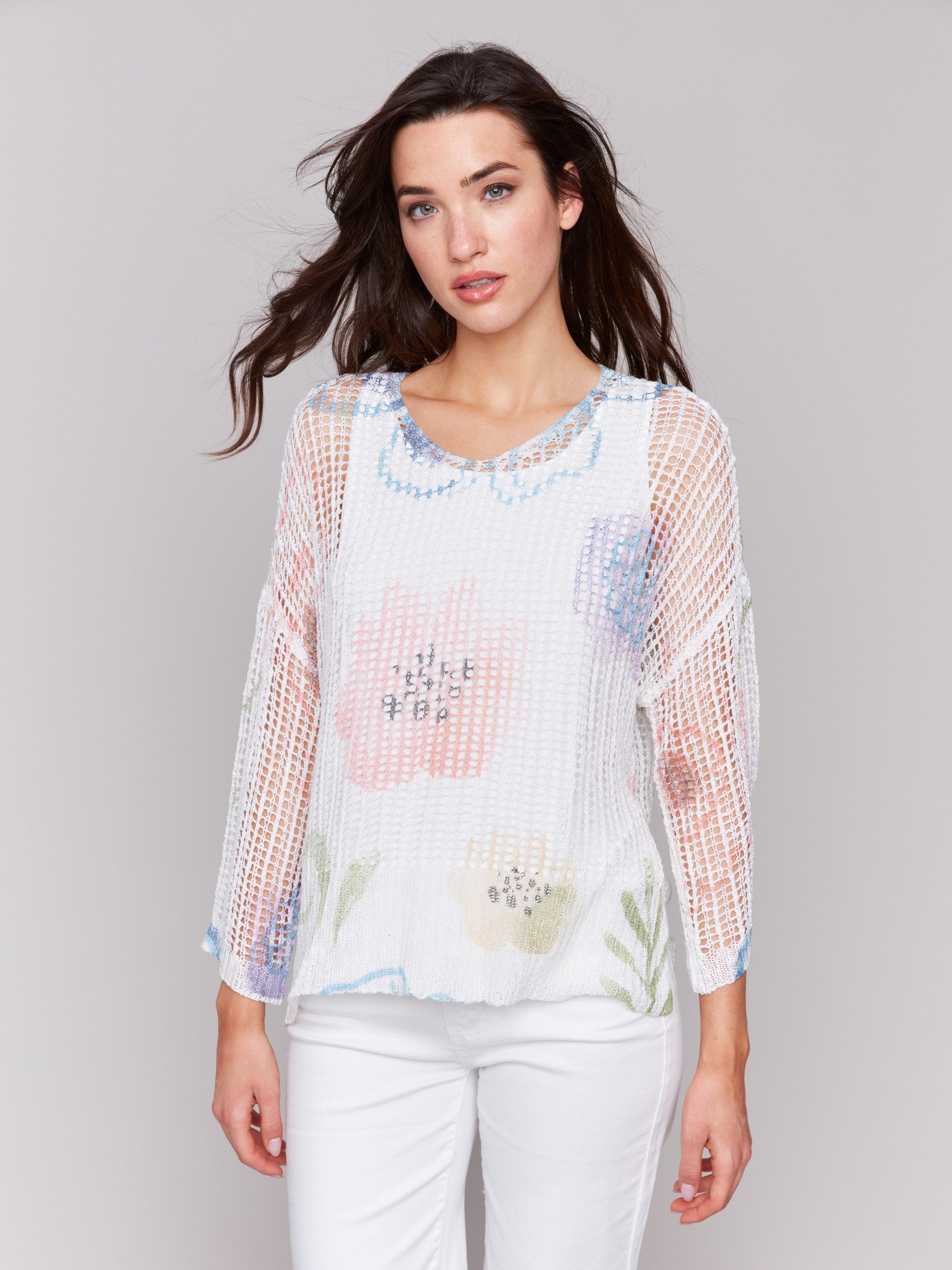 A lightweight V-neck crochet sweater with a watercolor print and loose fit by Charlie B.