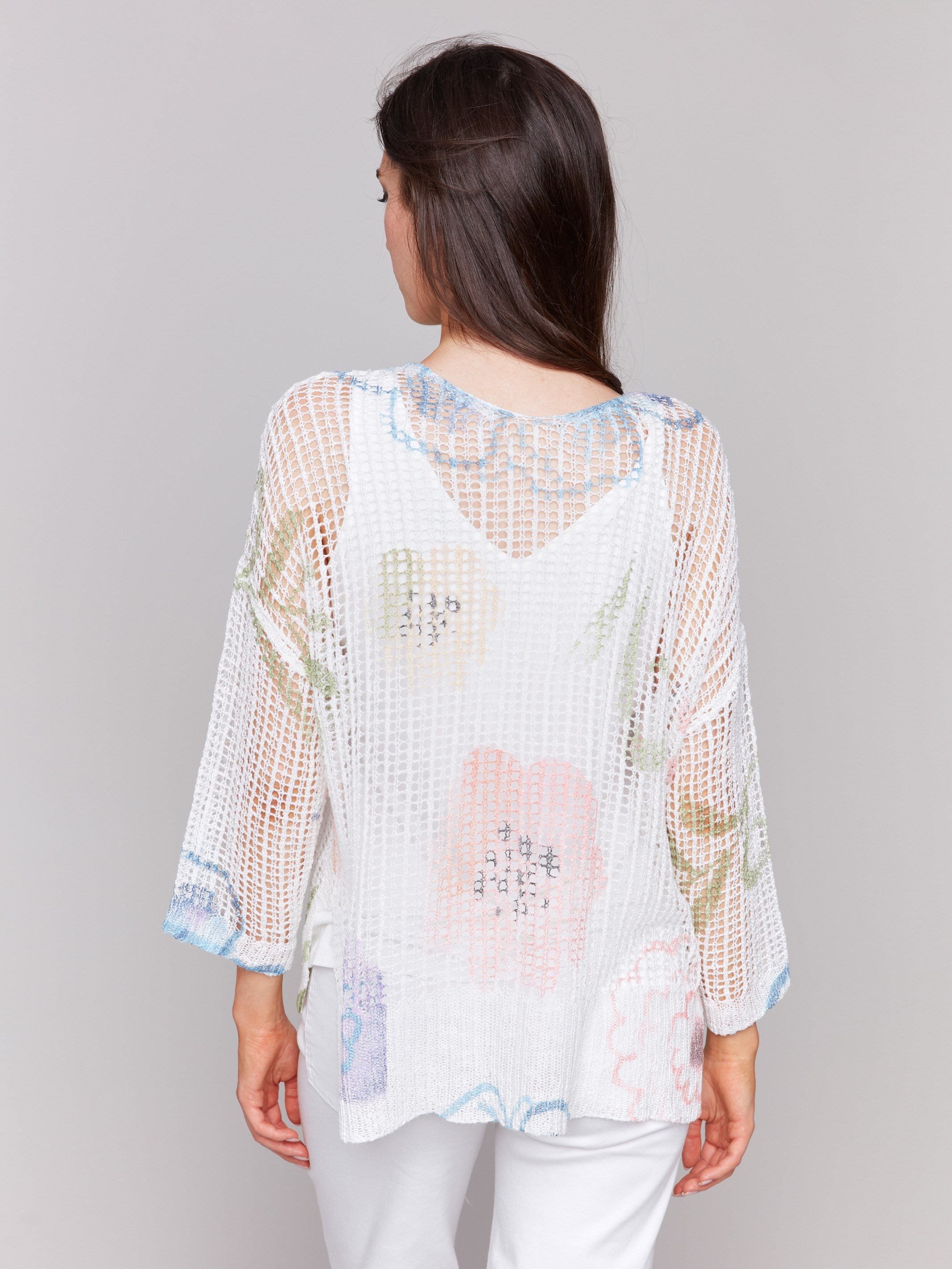 A lightweight V-neck crochet sweater with a watercolor print and loose fit by Charlie B.