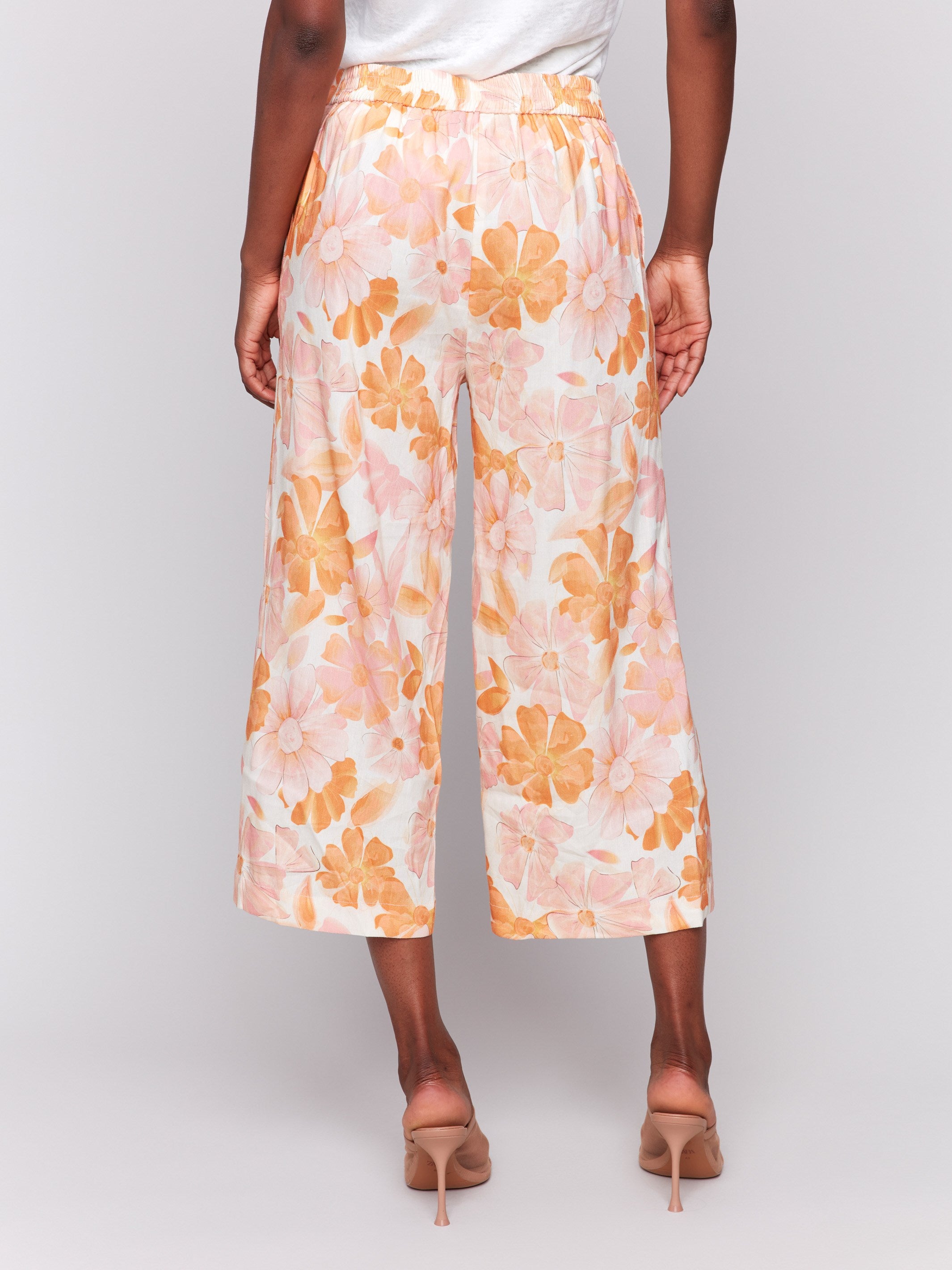 Cropped length linen pants in a blooming floral pattern by Charlie B.