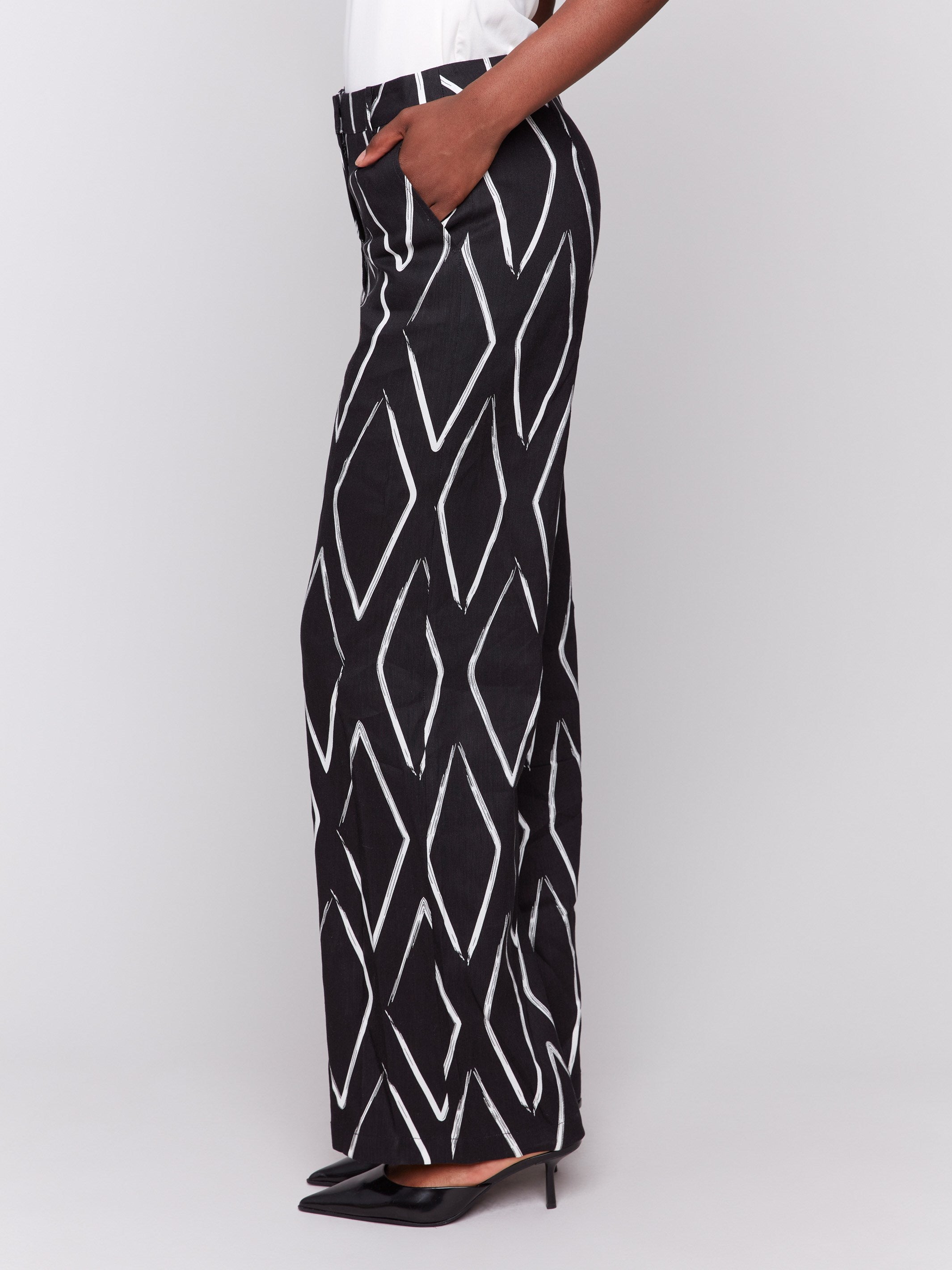 Stretch fabric pants with front pockets in a black and white pattern by Charlie B.