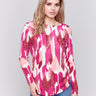 Fuchsia pink abstract print plush knit sweater with rounded hem and hidden pockets by Charlie B.