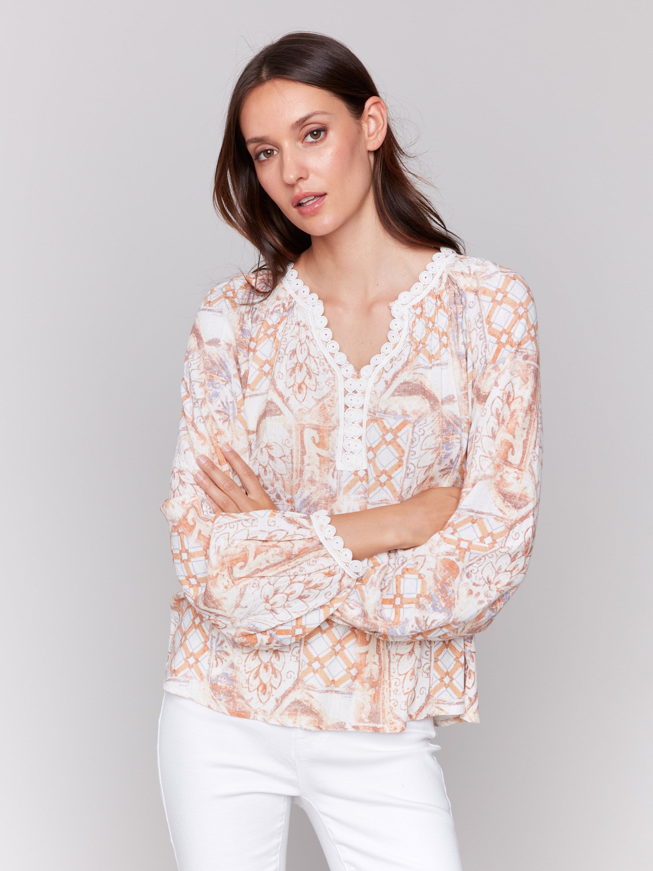 Papaya blouse featuring a V-notch neckline and lace trim by Charlie B.