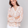 Papaya blouse featuring a V-notch neckline and lace trim by Charlie B.