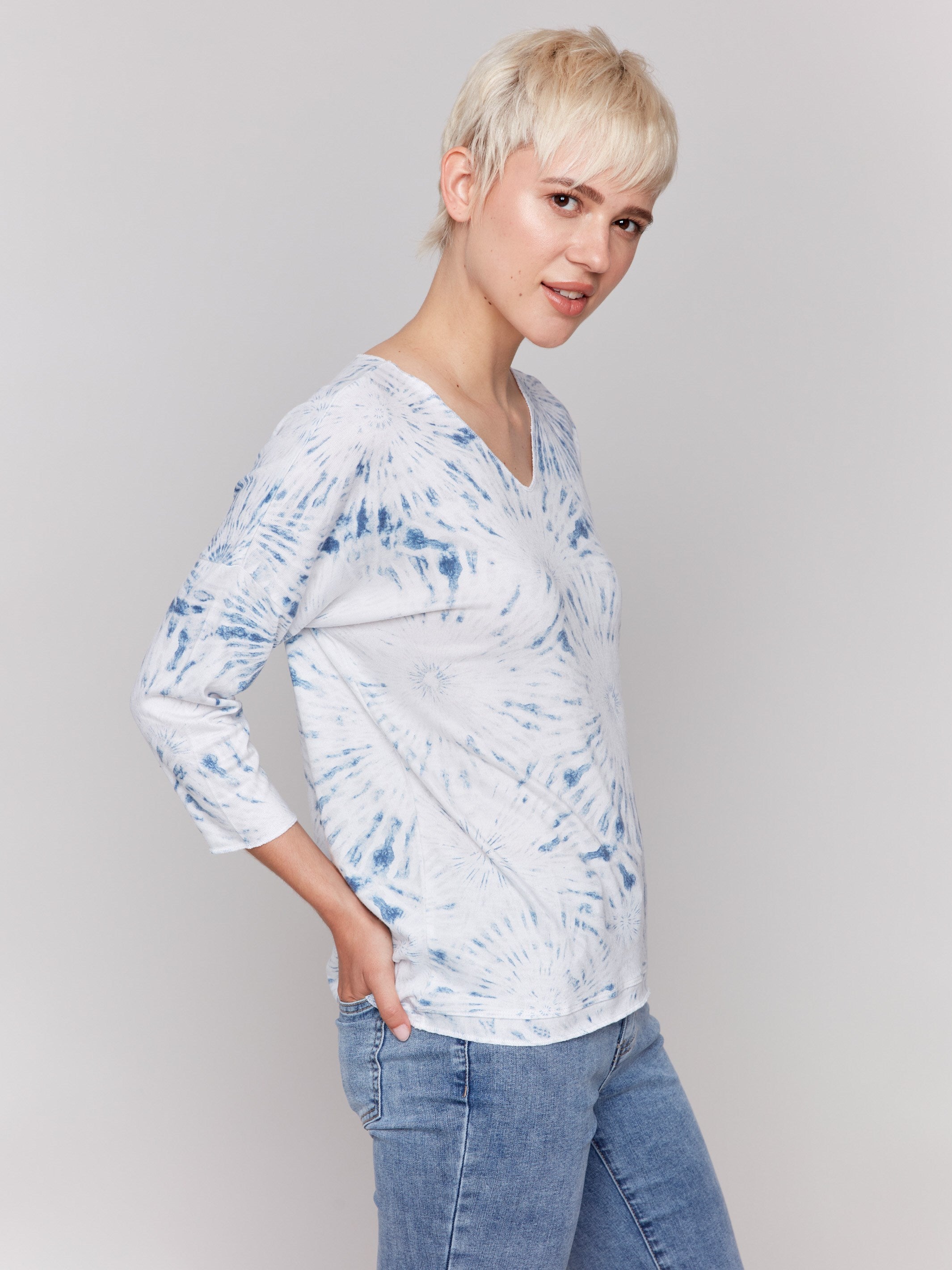 White V-neck knit top with denim tie-dye effect and drop shoulders by Charlie B.