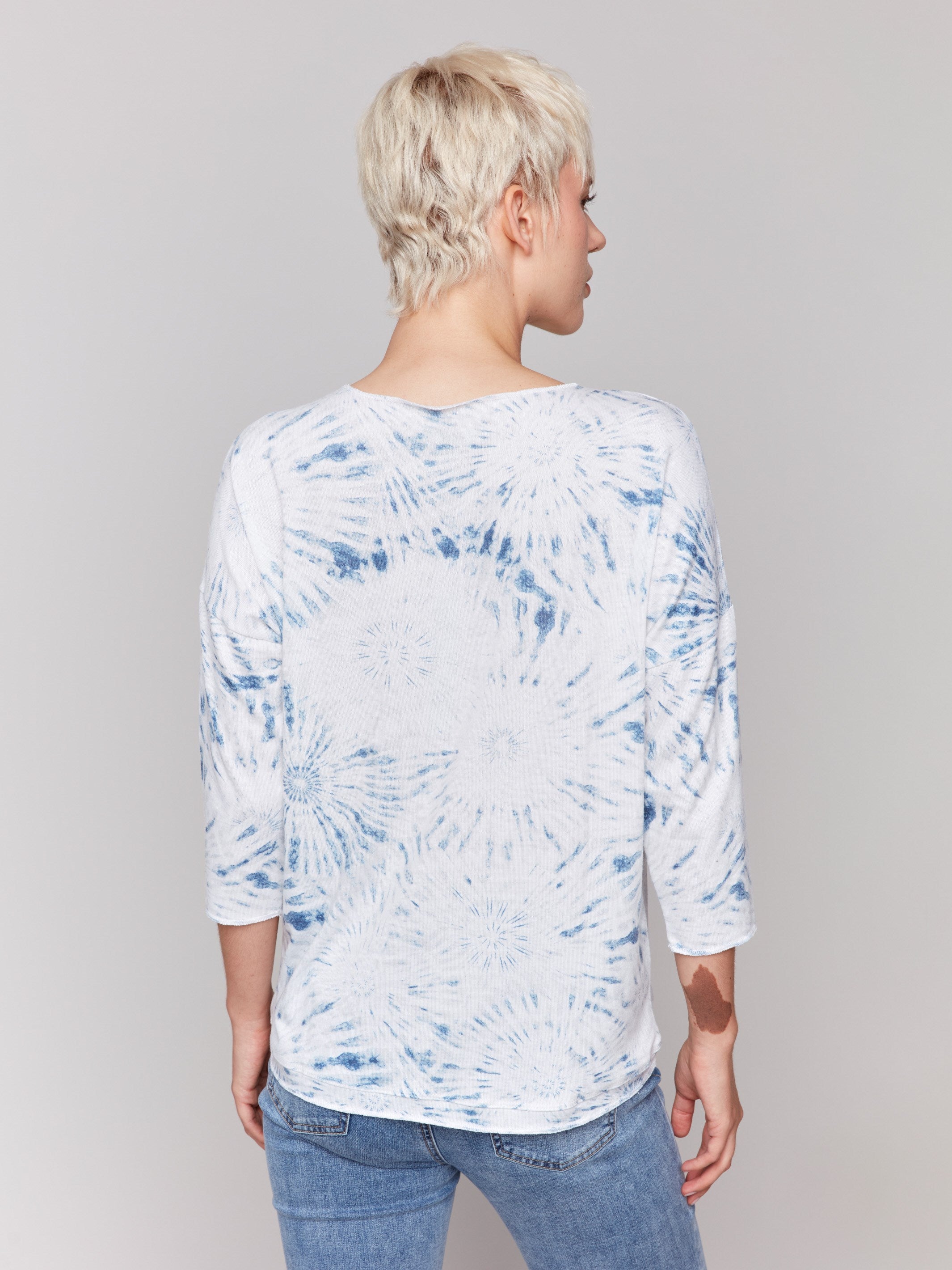 White V-neck knit top with denim tie-dye effect and drop shoulders by Charlie B.