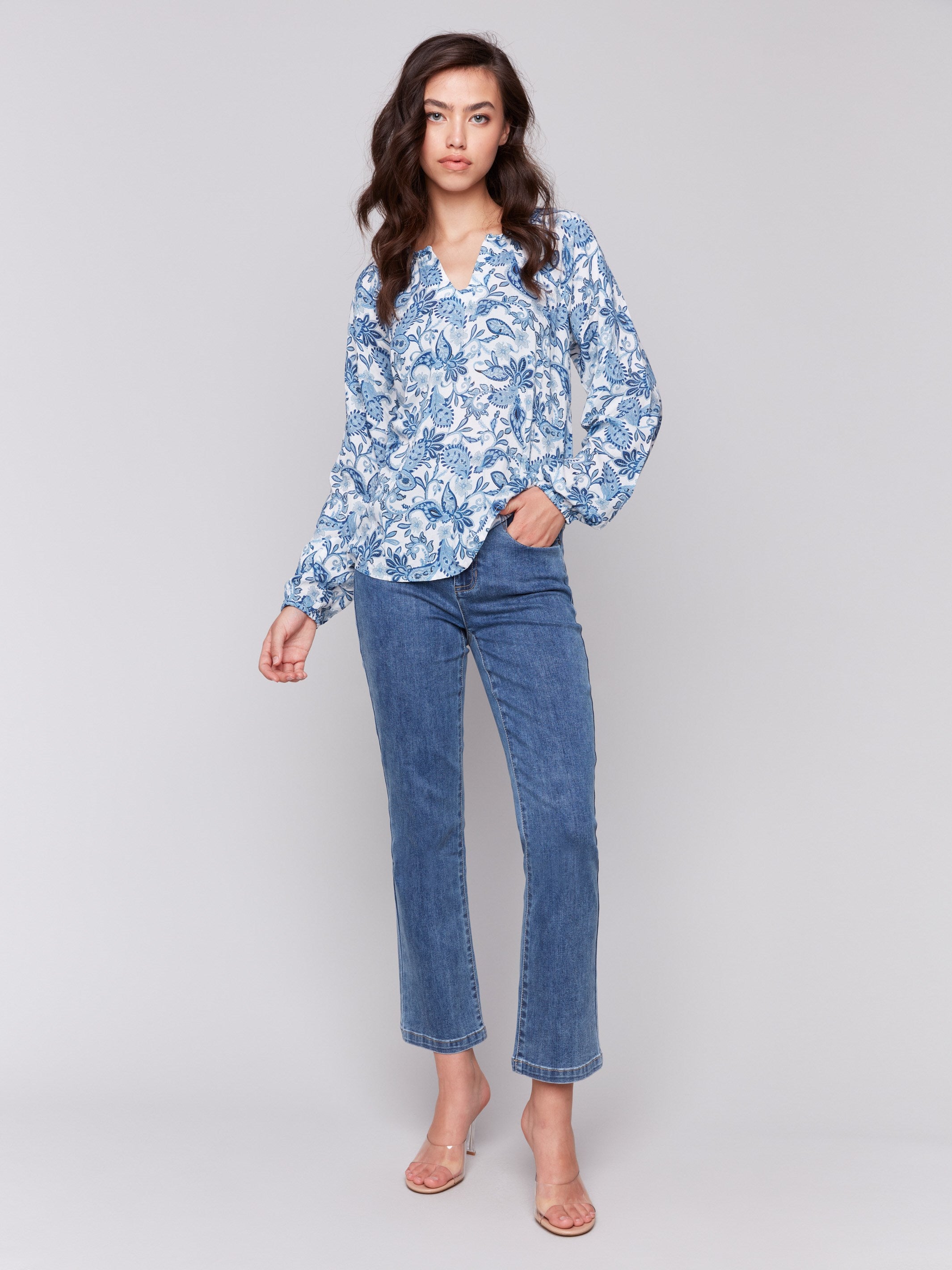 Blouse with twisted detail at neck in azure print by Charlie B.