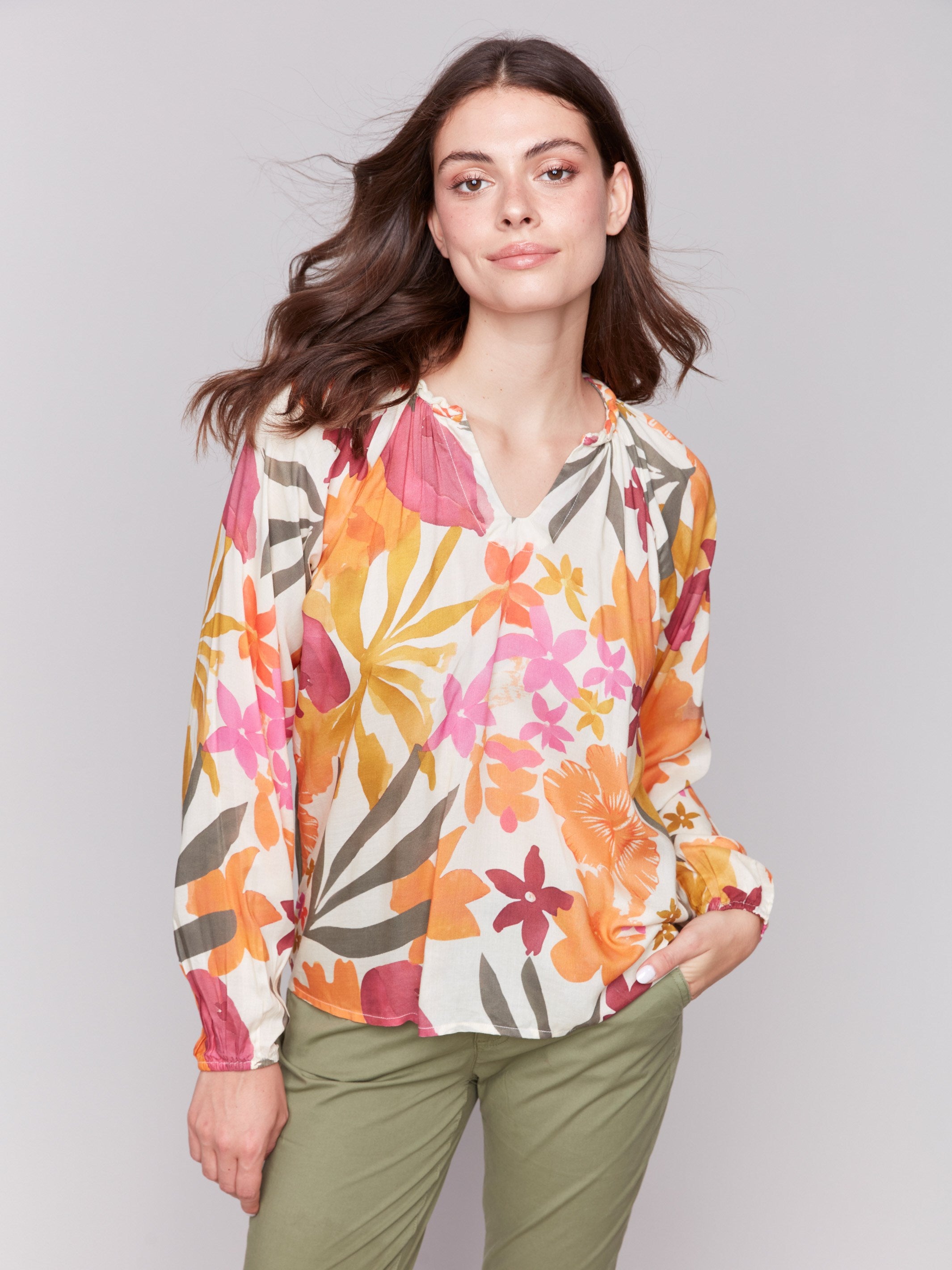 V-neck blouse with vibrant floral pattern by Charlie B.