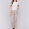 Beige pull-on flare twill pants with front buttons and a flare leg design by Charlie B.