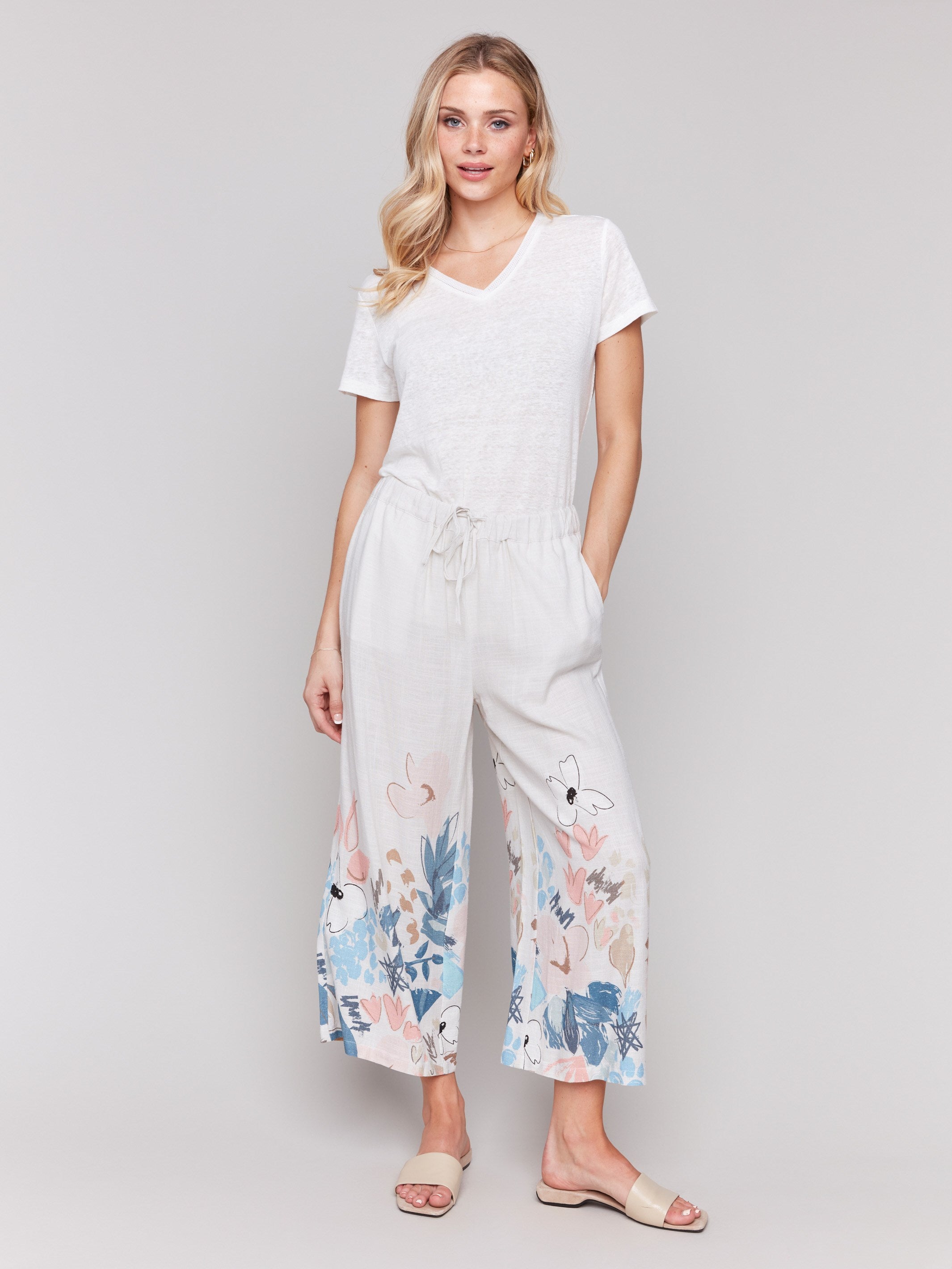 Linen blend pants with wide leg fit and floral accents, featuring a drawstring waist by Charlie B.