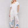 Linen blend pants with wide leg fit and floral accents, featuring a drawstring waist by Charlie B.