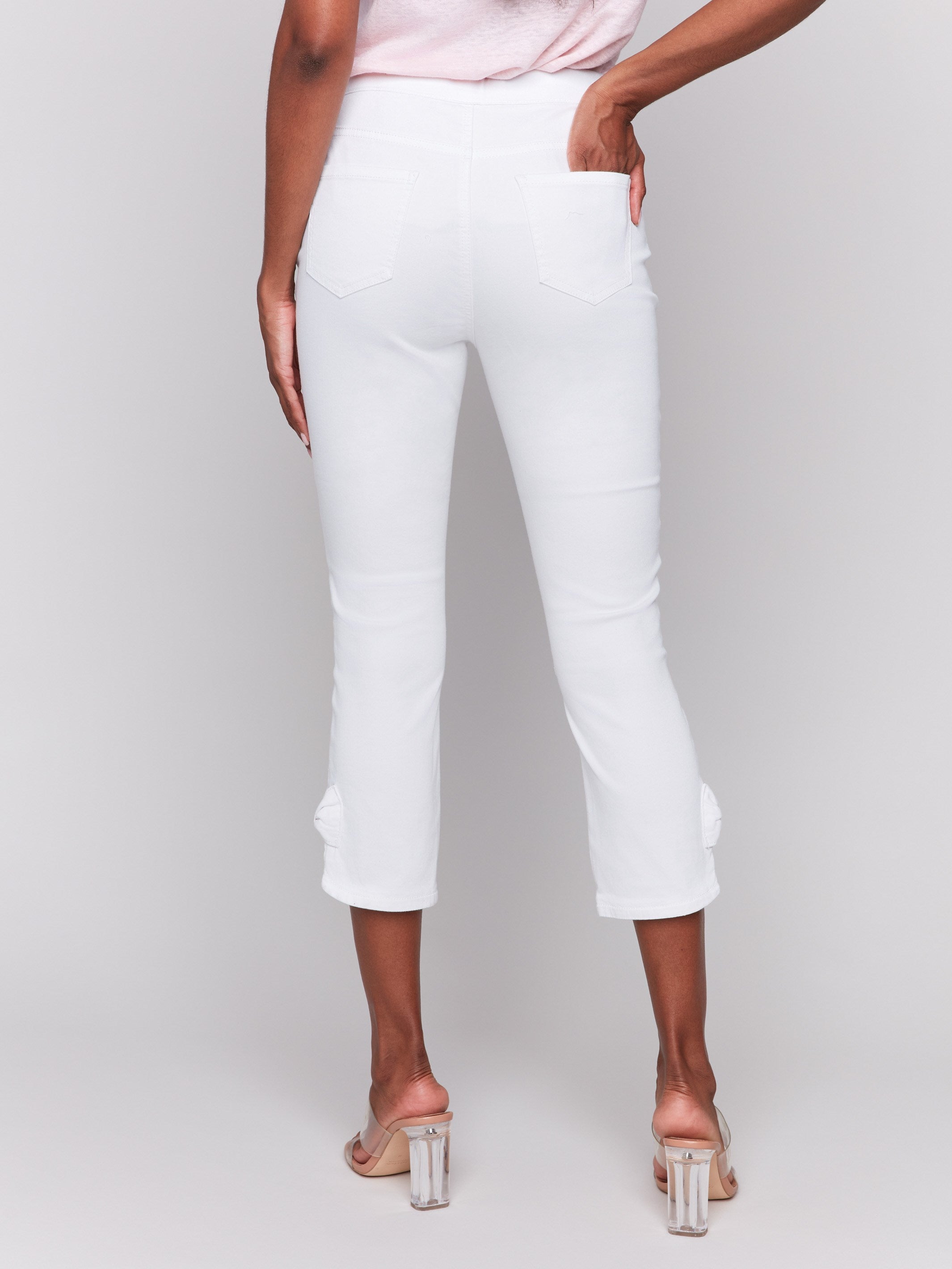 White pants with two faux front pockets and functional back pockets for added utility by Charlie B.