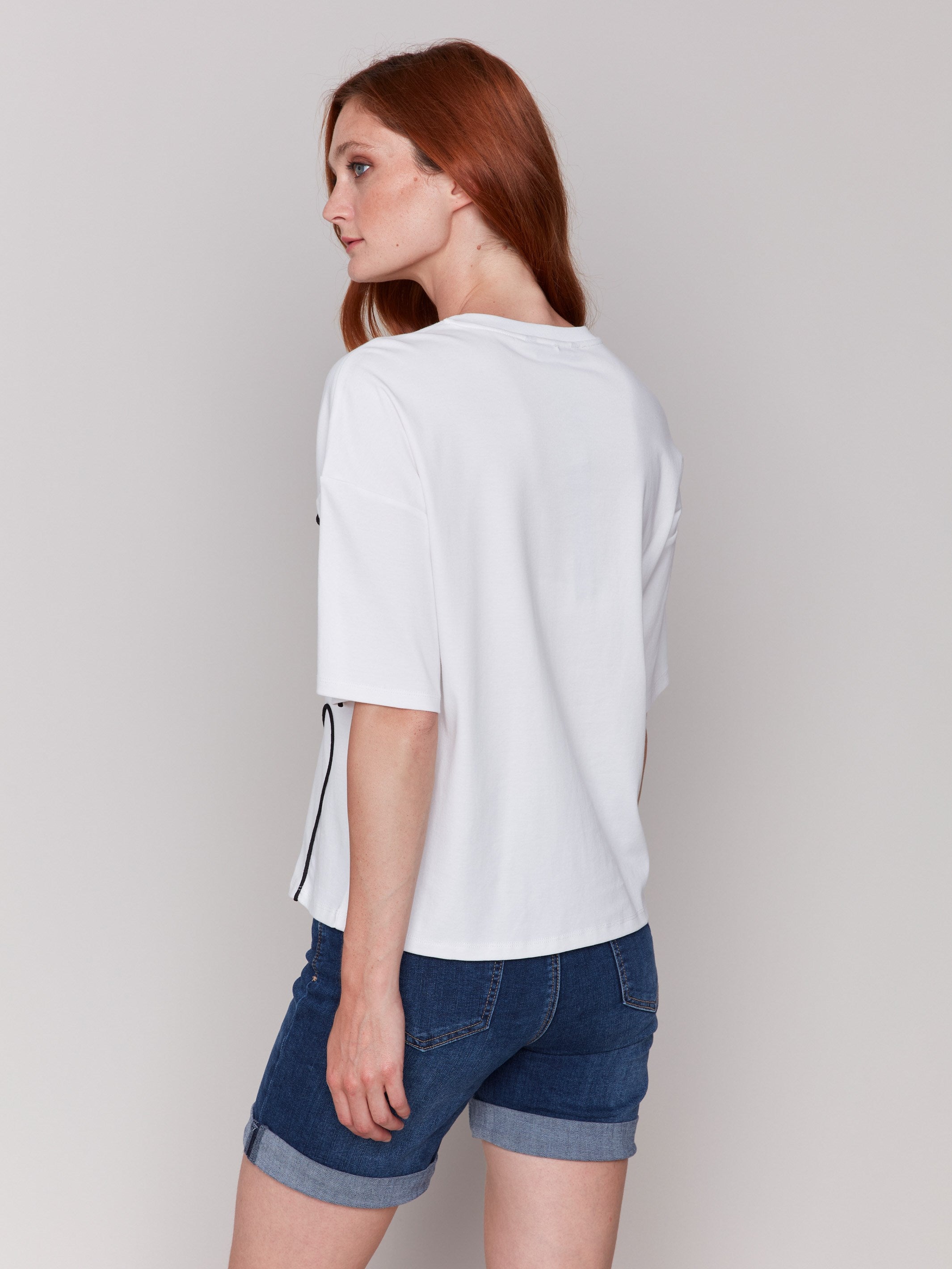 Relaxed fit white tee adorned with elegant black soutache embellishments by Charlie B.