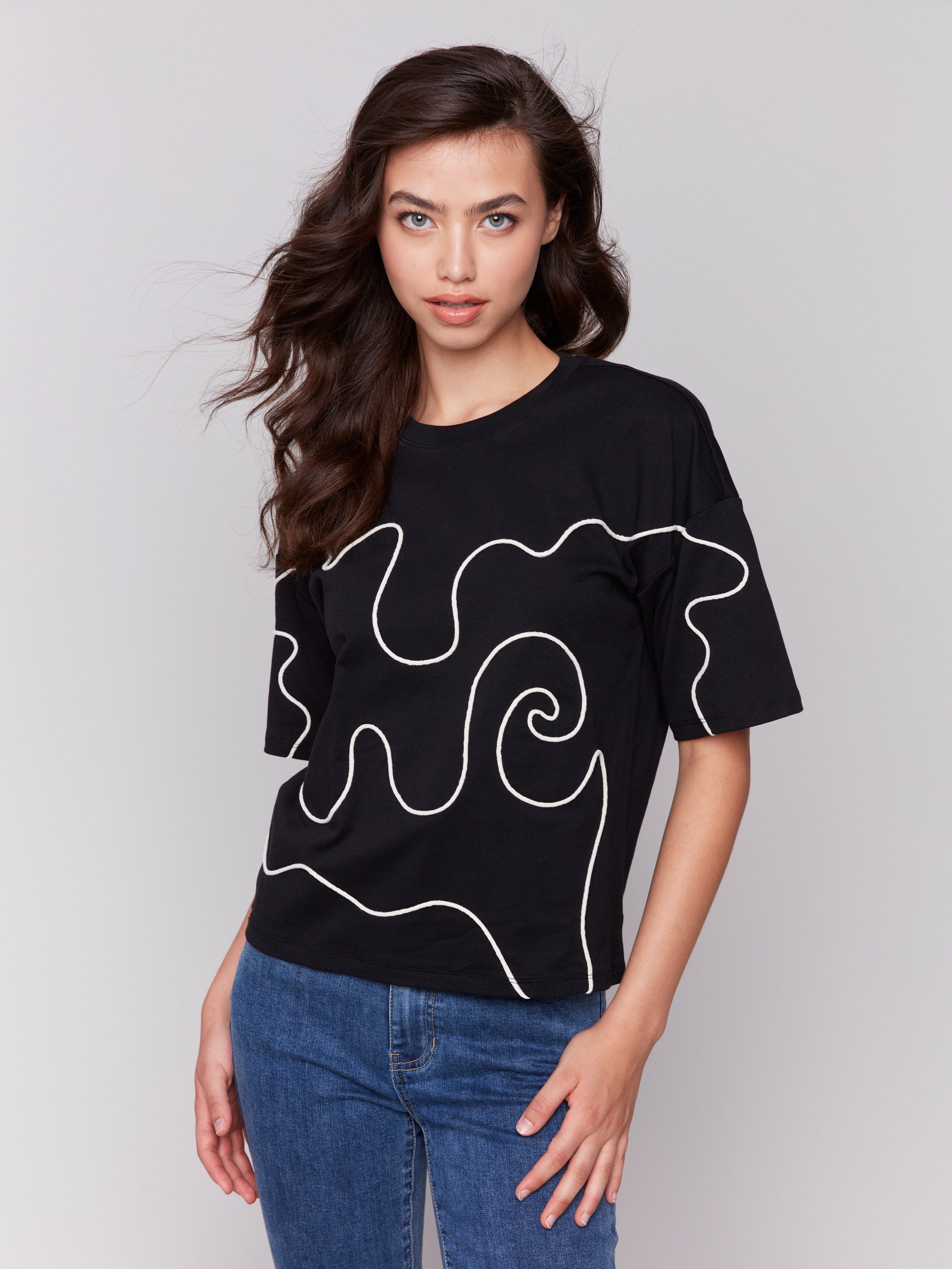 Black t-shirt with a relaxed fit and drop shoulder design by Charlie B.