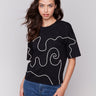 Black t-shirt with a relaxed fit and drop shoulder design by Charlie B.