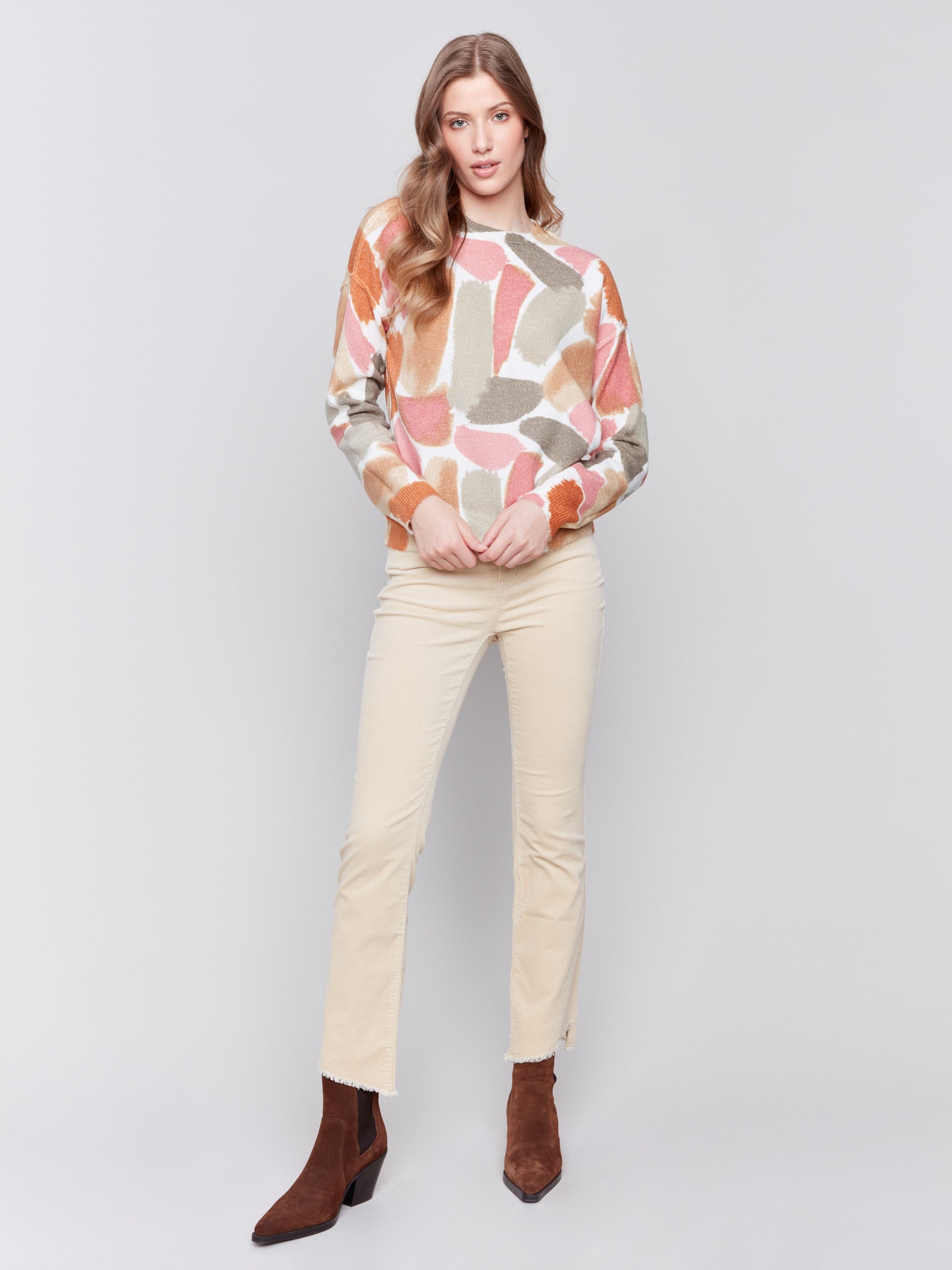 Women wearing reversible printed sweater with artistic prints and a crew neckline by Charlie B.