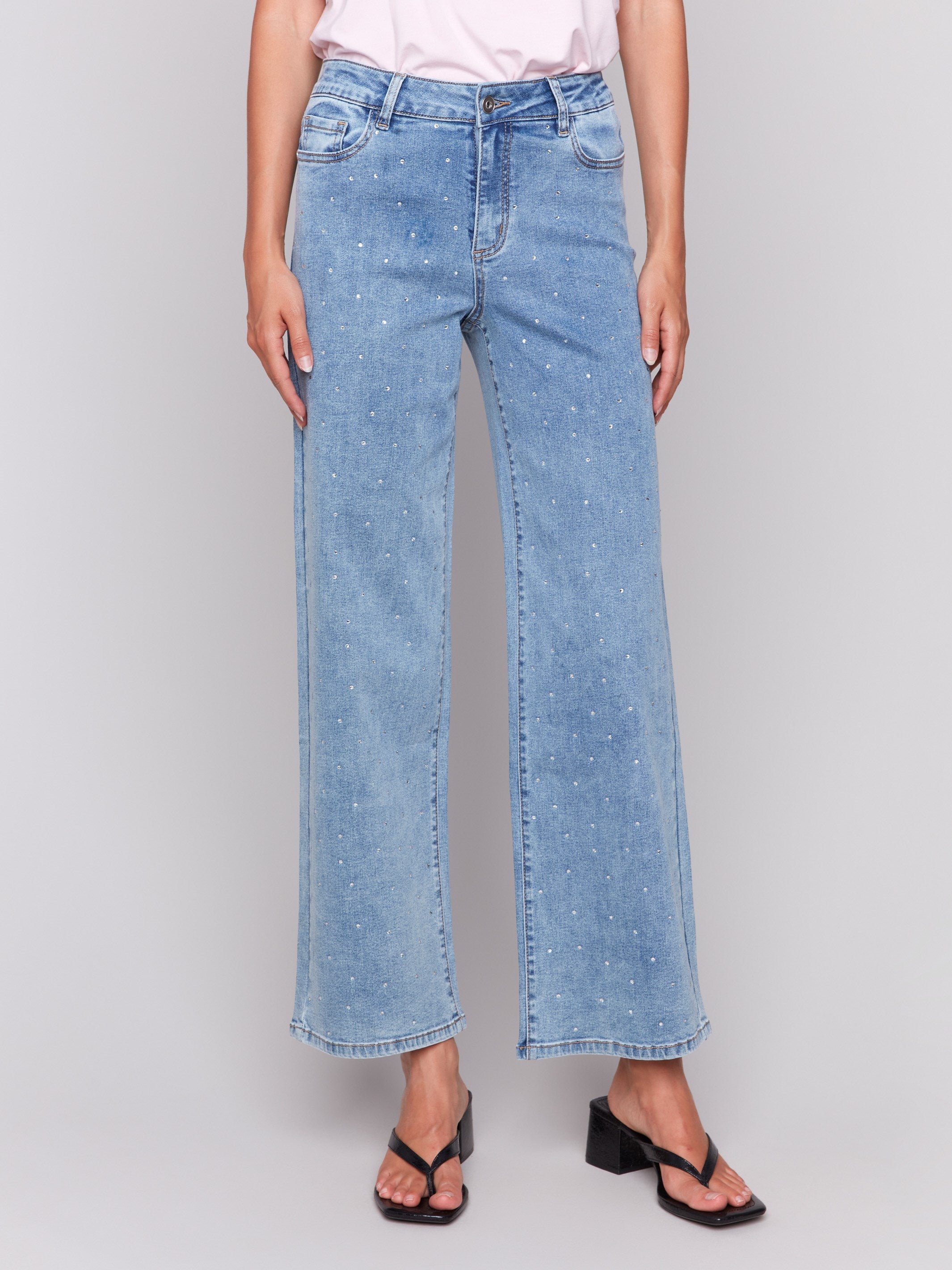 Light blue jeans featuring rhinestones all over with a wide-leg cut by Charlie B.