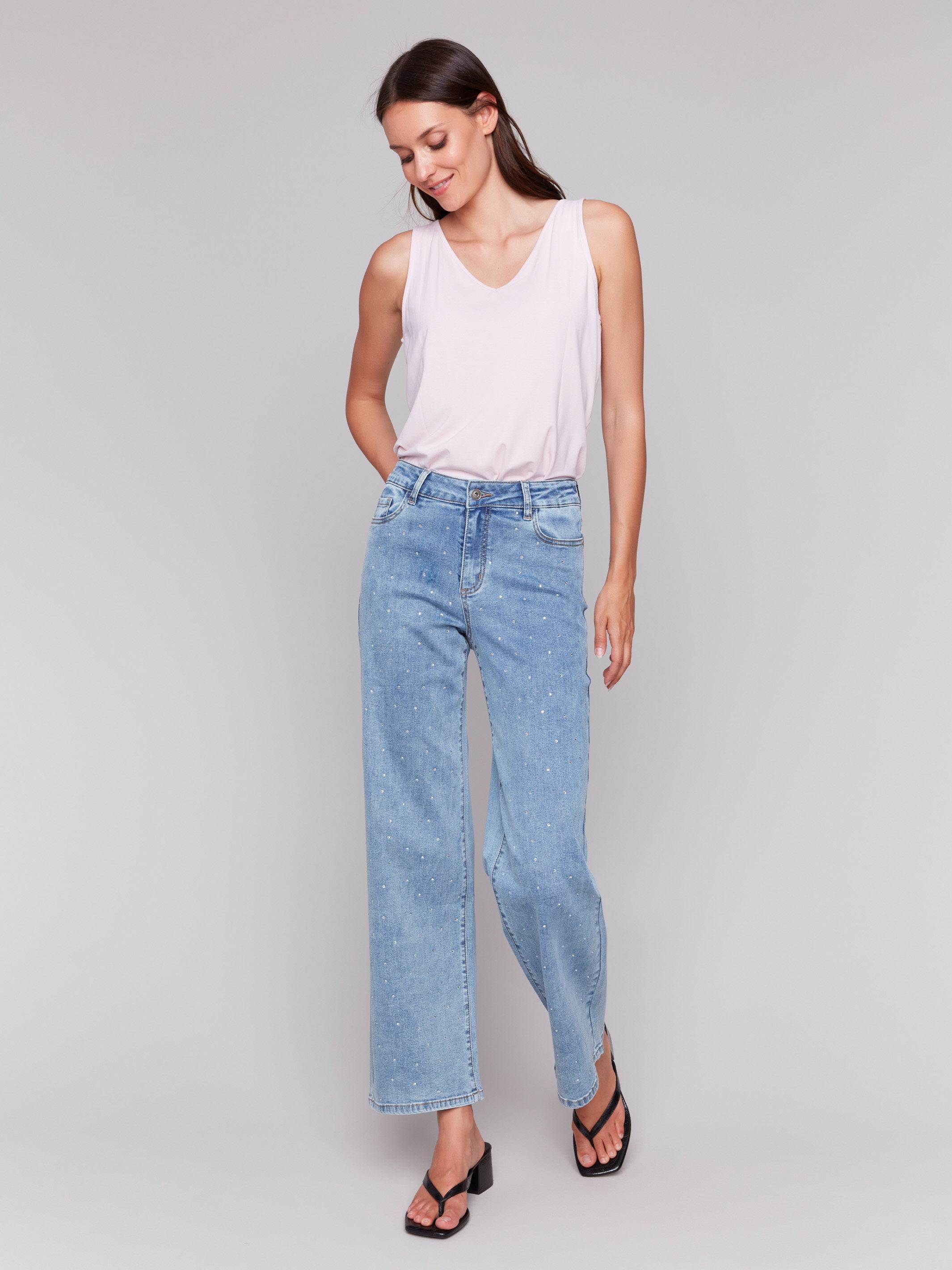 Light blue jeans featuring rhinestones all over with a wide-leg cut by Charlie B.