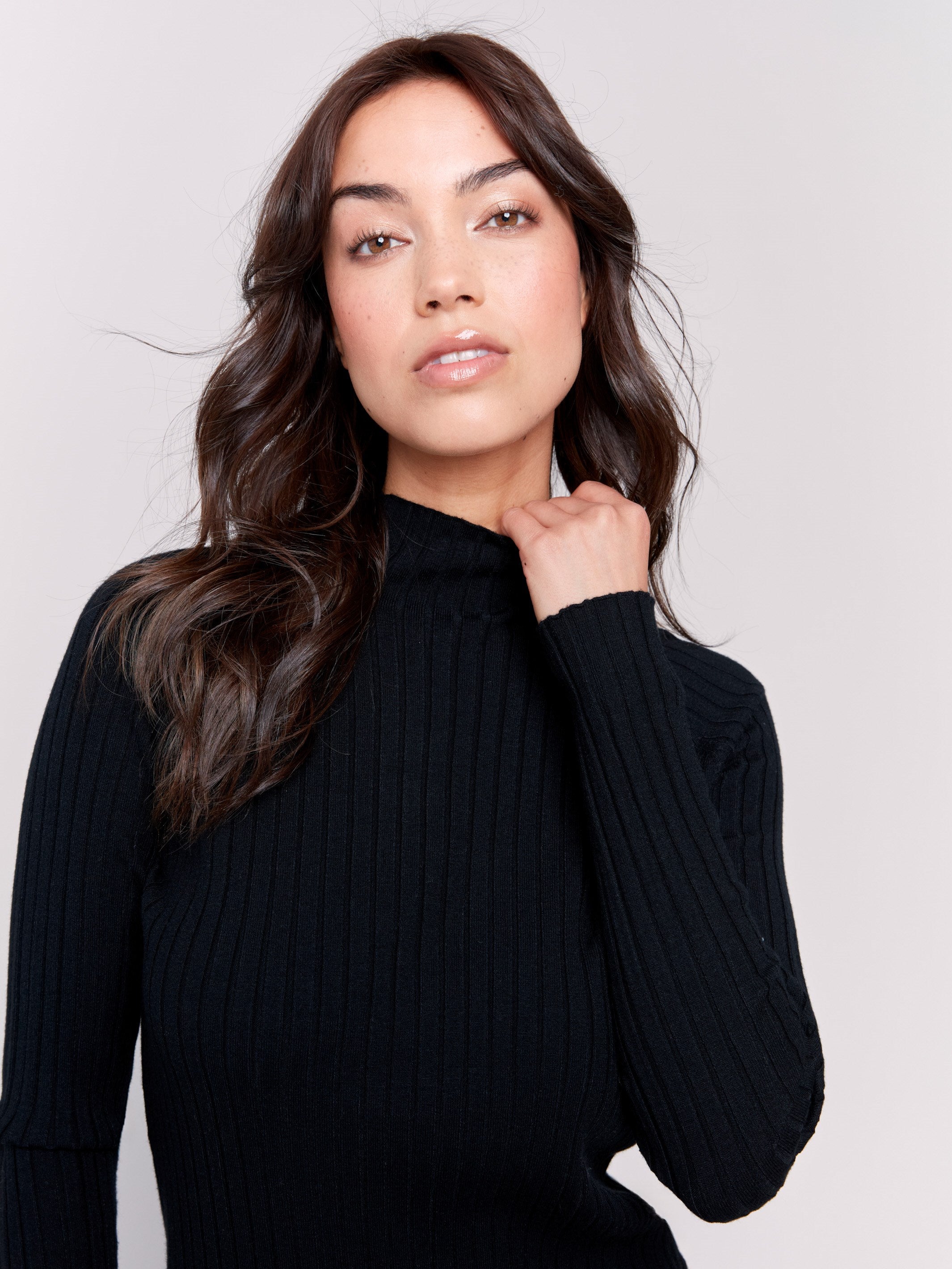 Black ribbed knit sweater with a mock neck and long sleeves by Charlie B.