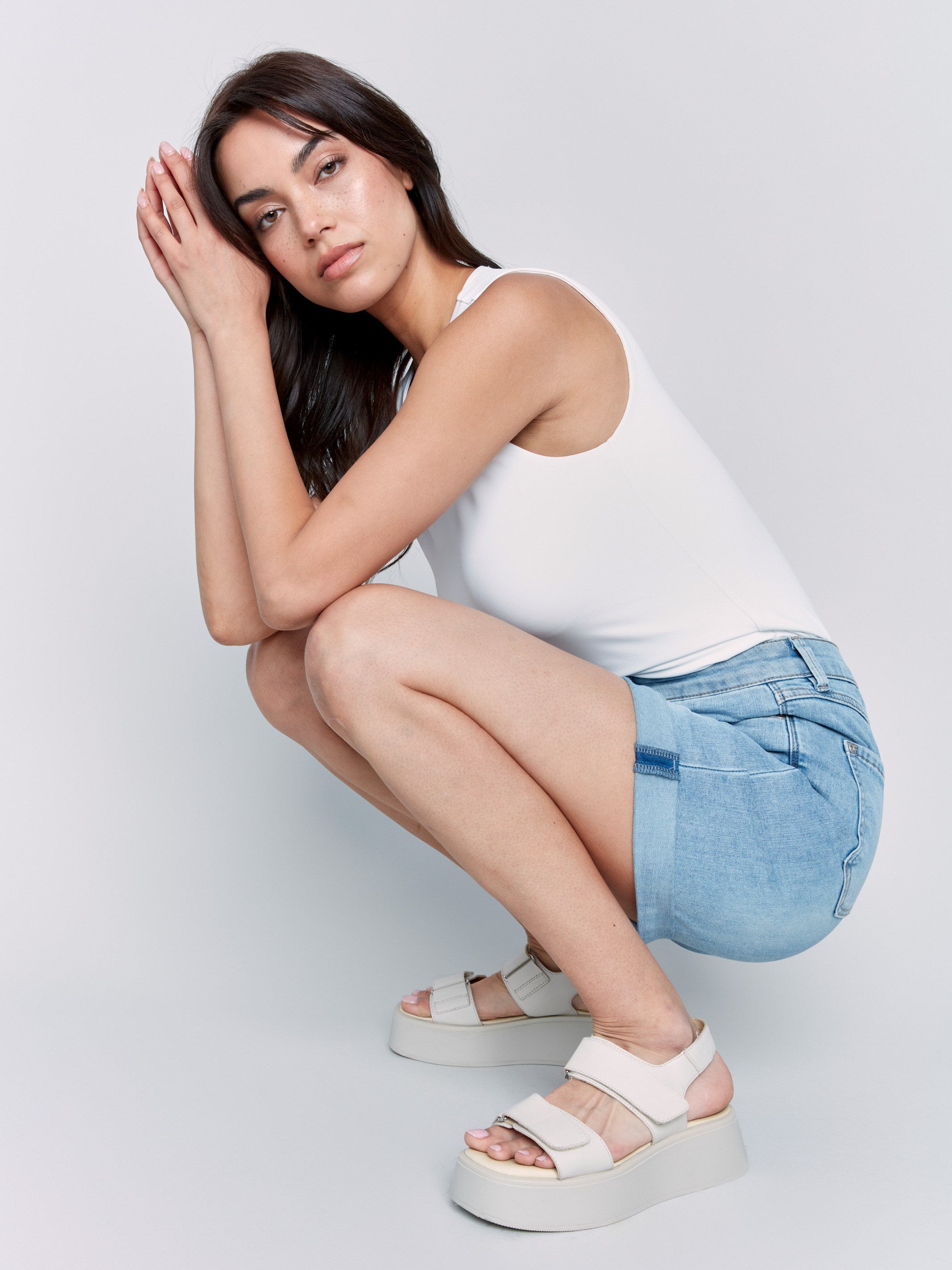 Rolled cuff denim shorts in a light blue hue, offering regular rise fit by Charlie B.