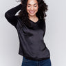 Black satin and jersey top featuring V-neck design and long sleeves by Charlie B.