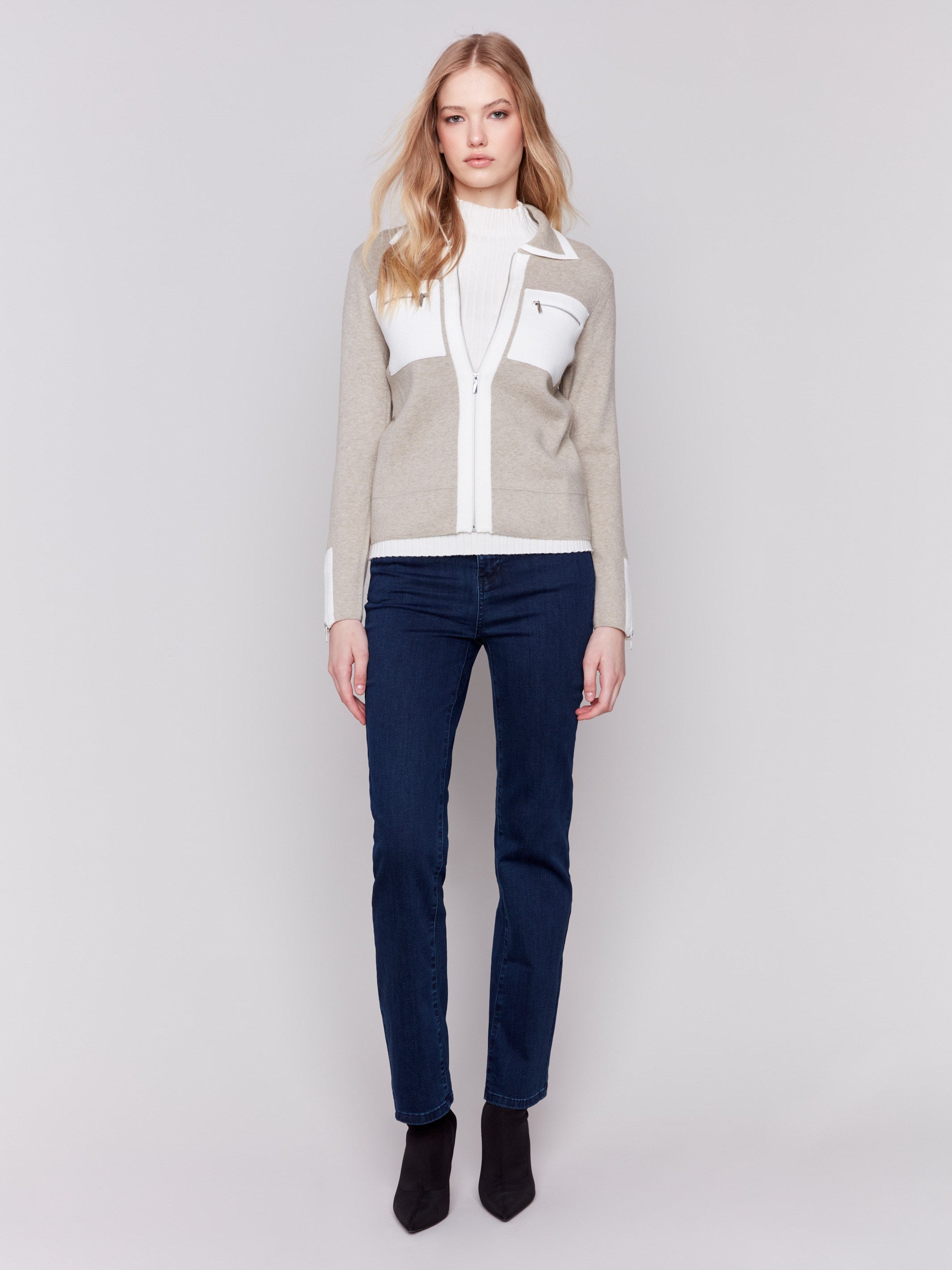 Beige short knit jacket with zipper closure and patch front pockets featuring stylish design by Charlie B.