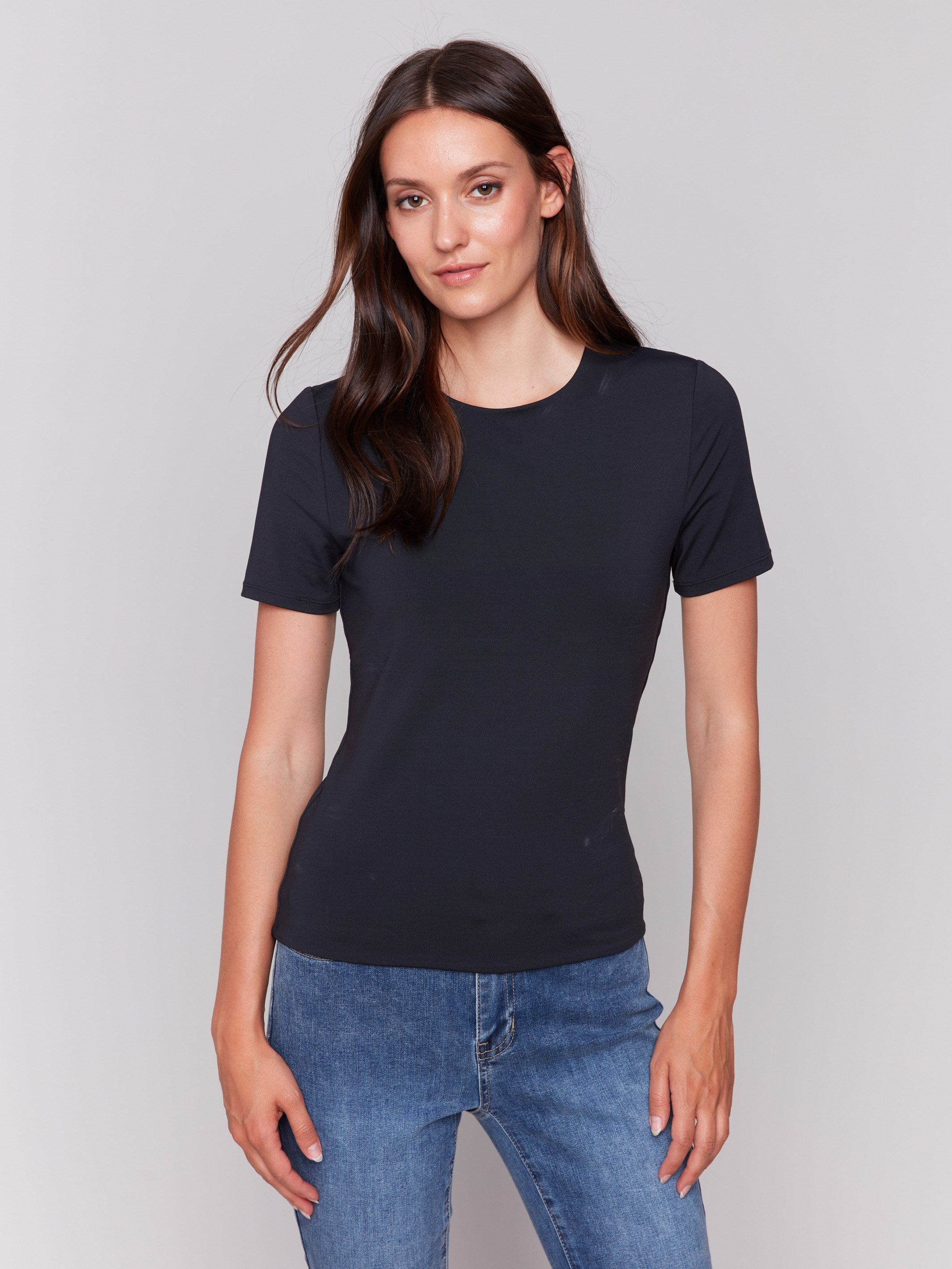 Black short-sleeved super stretch top with a crew neckline, showcasing a slim fit design by Charlie B.