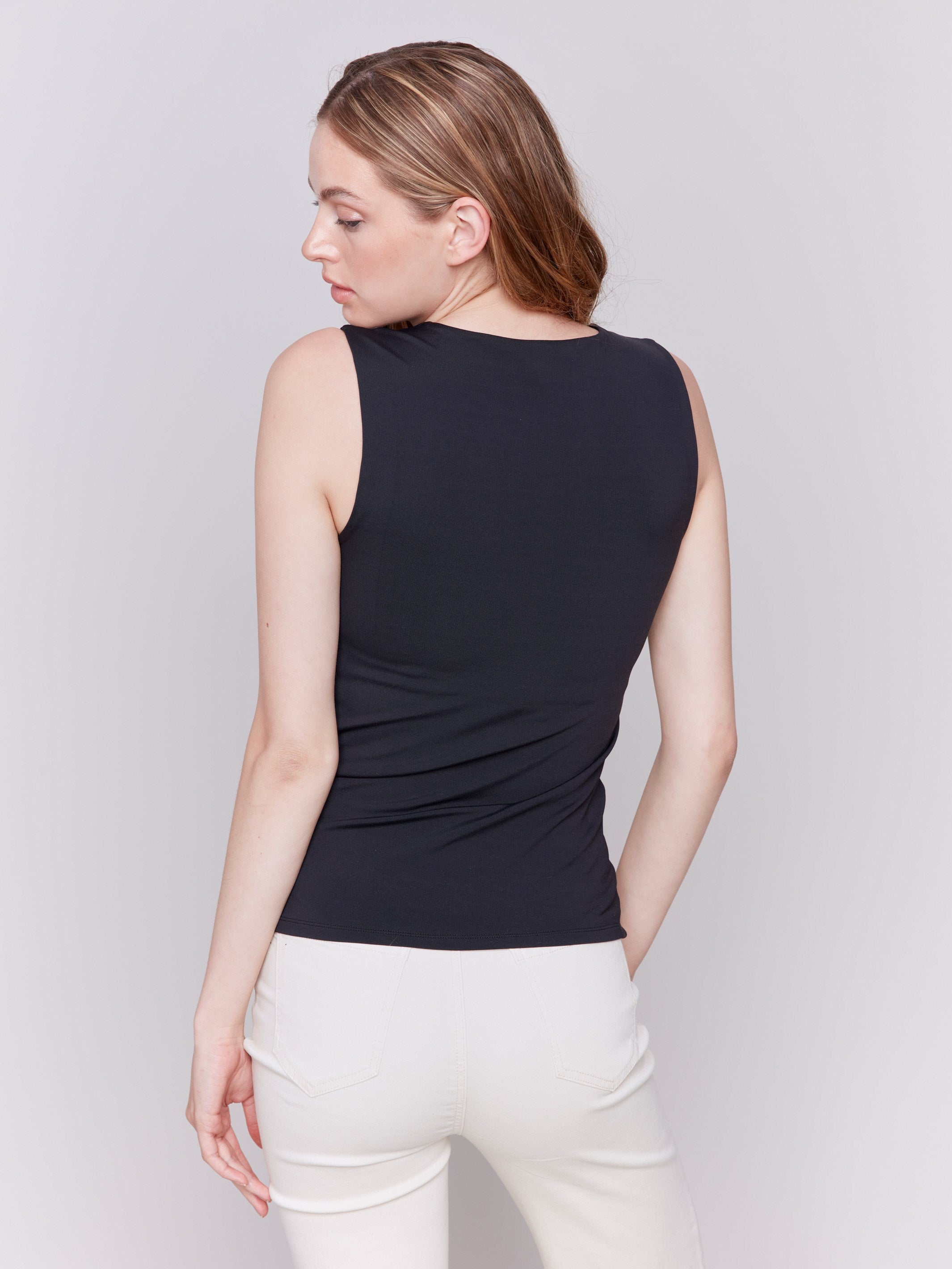 Black sleeveless super stretch top with a crew neckline by Charlie B.