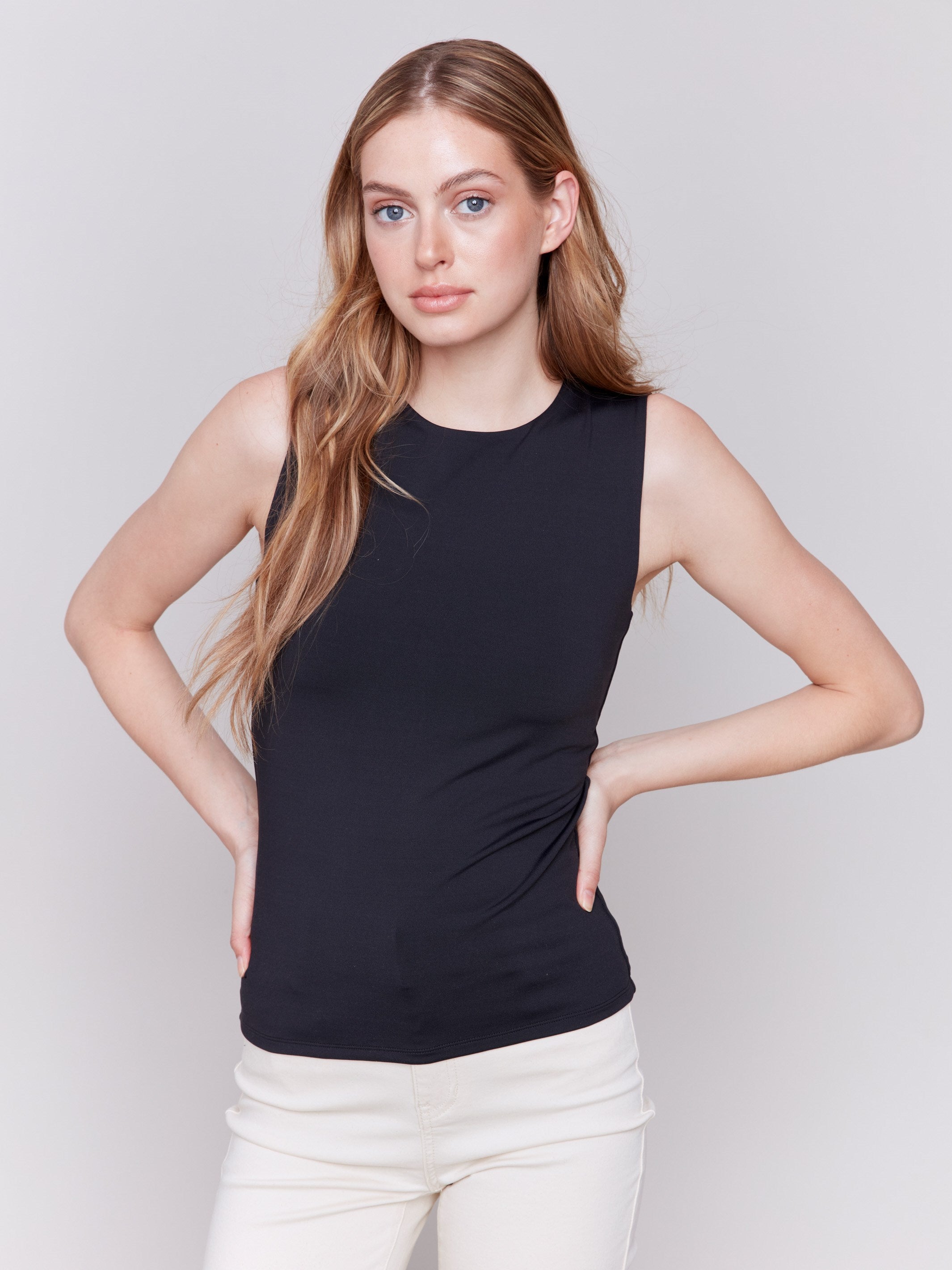 Black sleeveless super stretch top with a crew neckline by Charlie B.