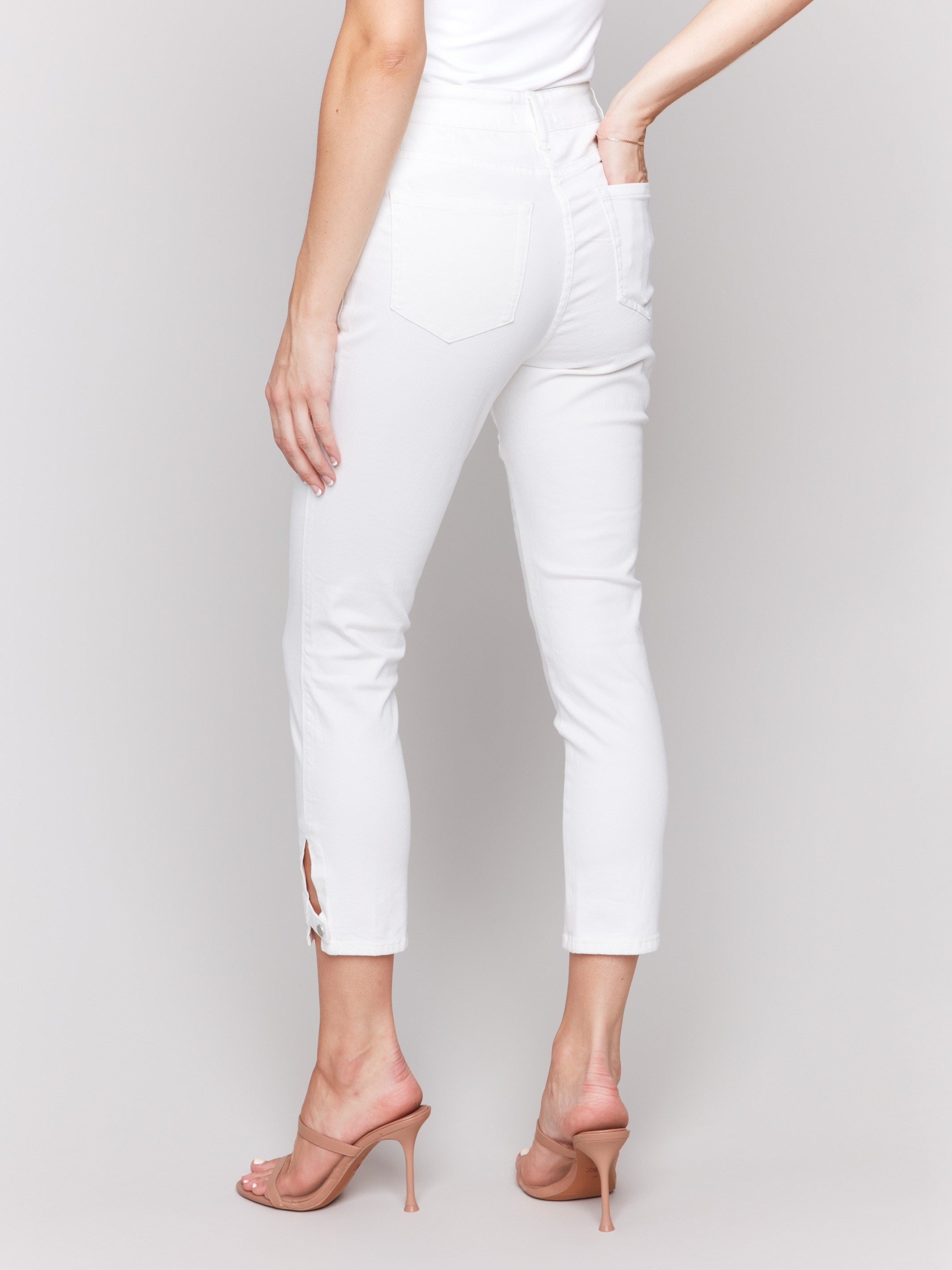 White slim cropped pants designed with a regular rise by Charlie B.